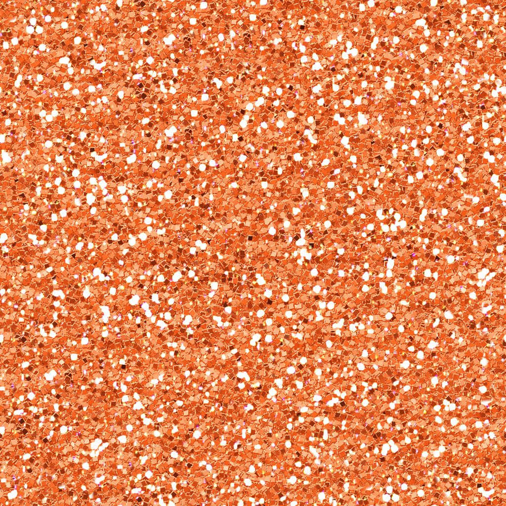 Orange Glitter 桌布 壁紙 — 密集嘅銅橙色閃粉粒子場，帶有散落嘅白色斑點，喺光線下閃爍。