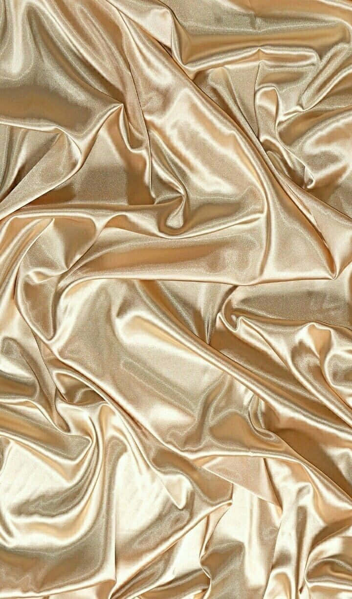 金色絲綢布料，帶有優雅的褶皺和反射光澤。