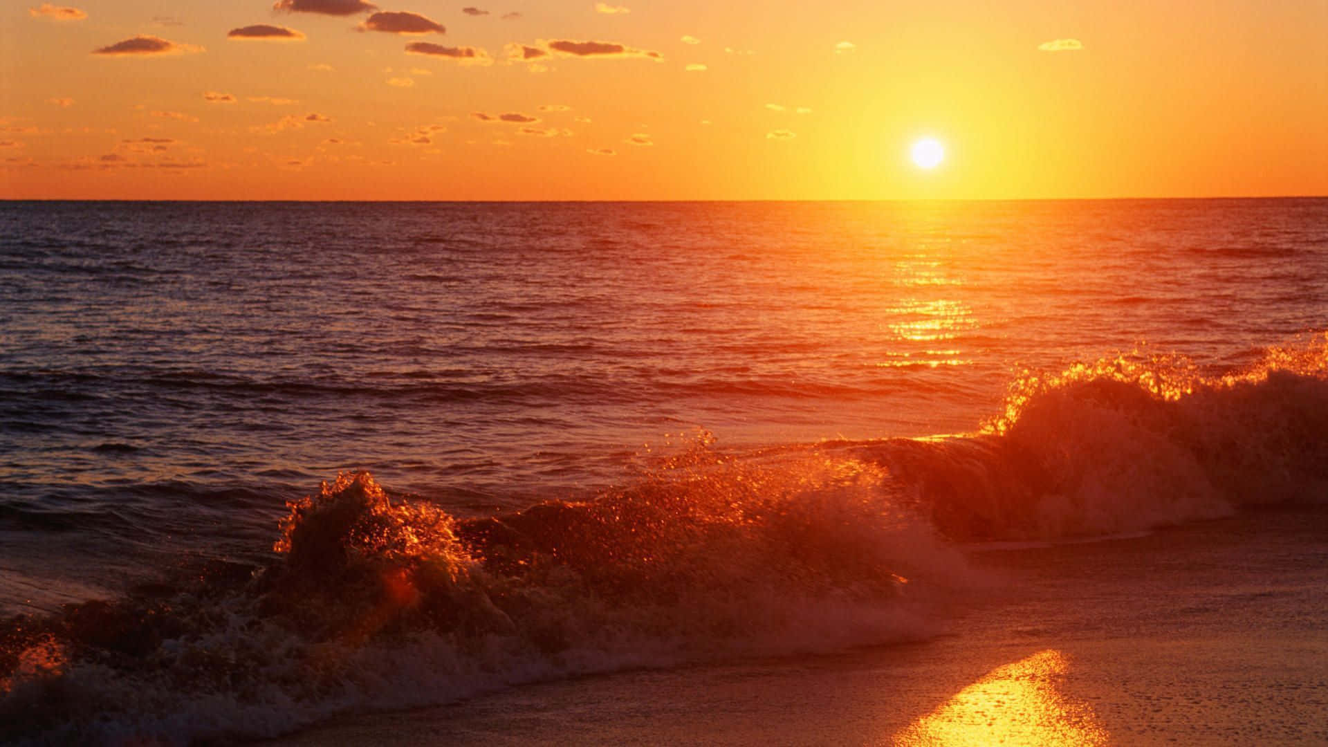 夕陽下的海洋，波浪衝擊沙灘