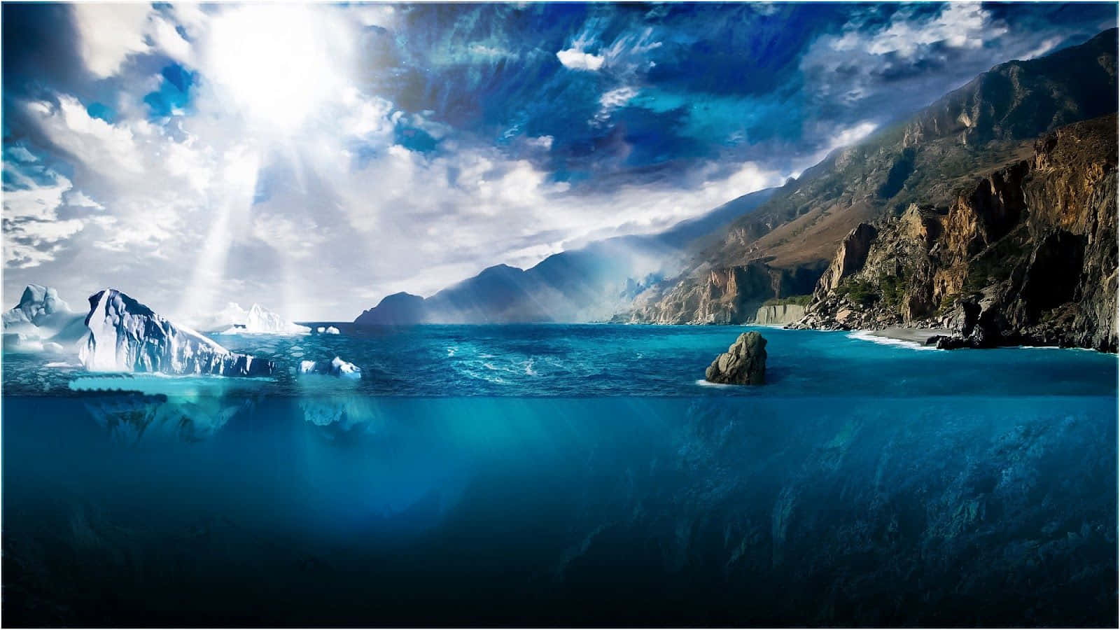 寬屏中的森林風景 壁紙 — 陽光穿透暴風雲層，照耀著一個戲劇性的海岸灣，冰山和岩石懸崖在水面上下清晰可見。