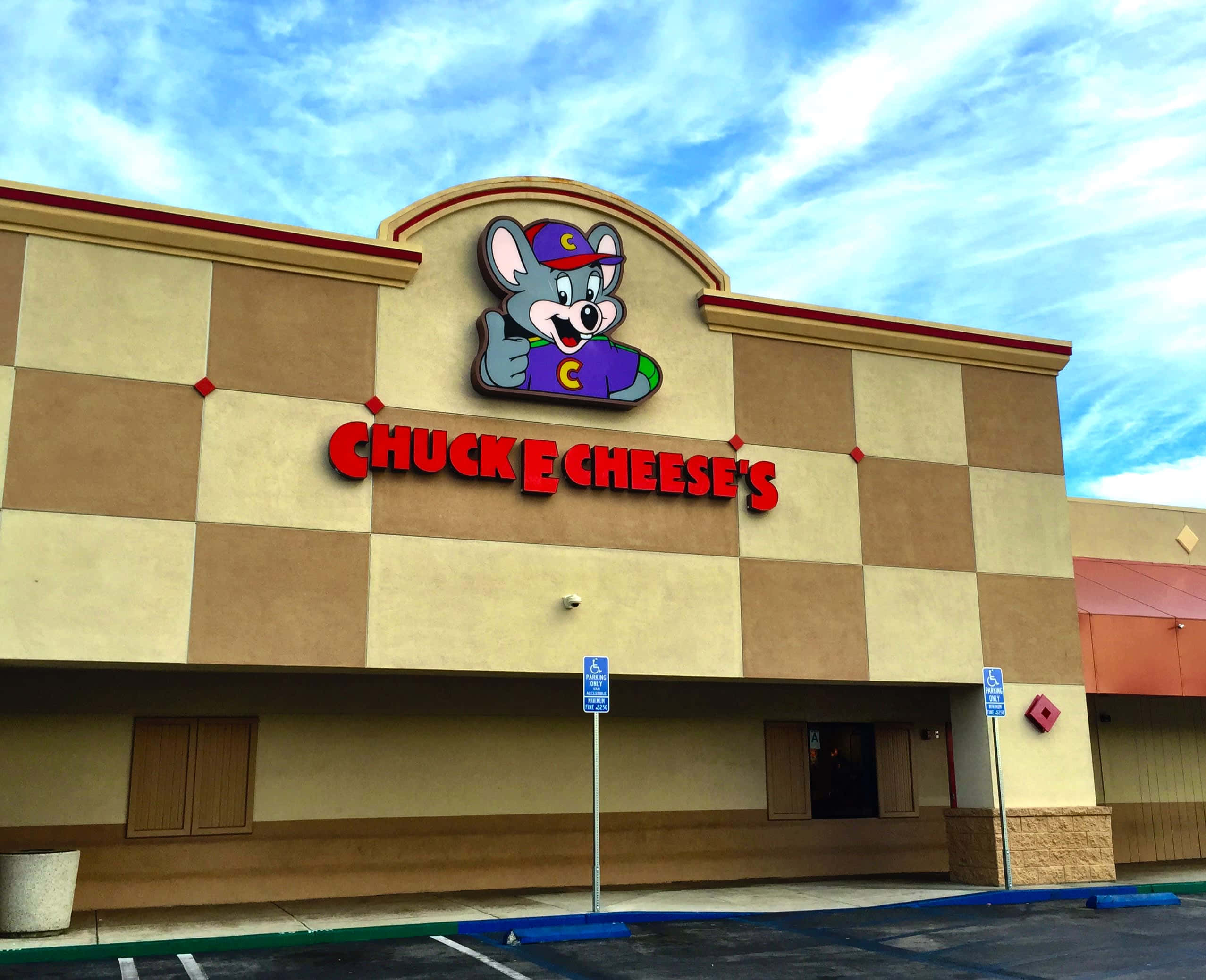 Chuck E Cheese's 餐廳，卡通老鼠吉祥物，棋盤格外觀。