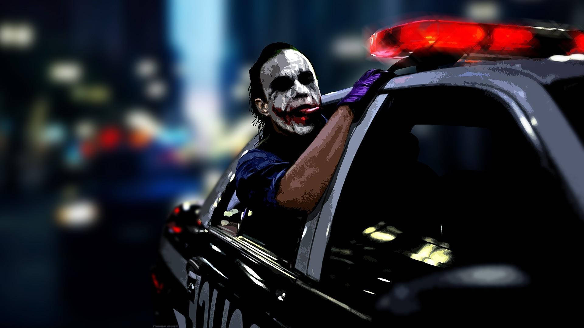 小丑在夜晚的城市中從亮著紅燈的警車中探出身子。