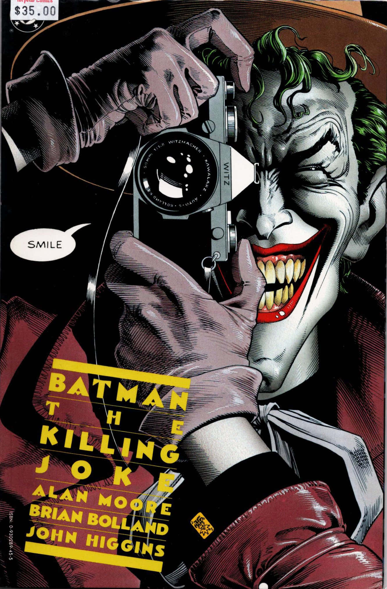 Batman The Killing Joke 桌布 壁紙 — 小丑狂笑著將相機貼近臉部，漫畫封面上的對話框寫著「SMILE」。
