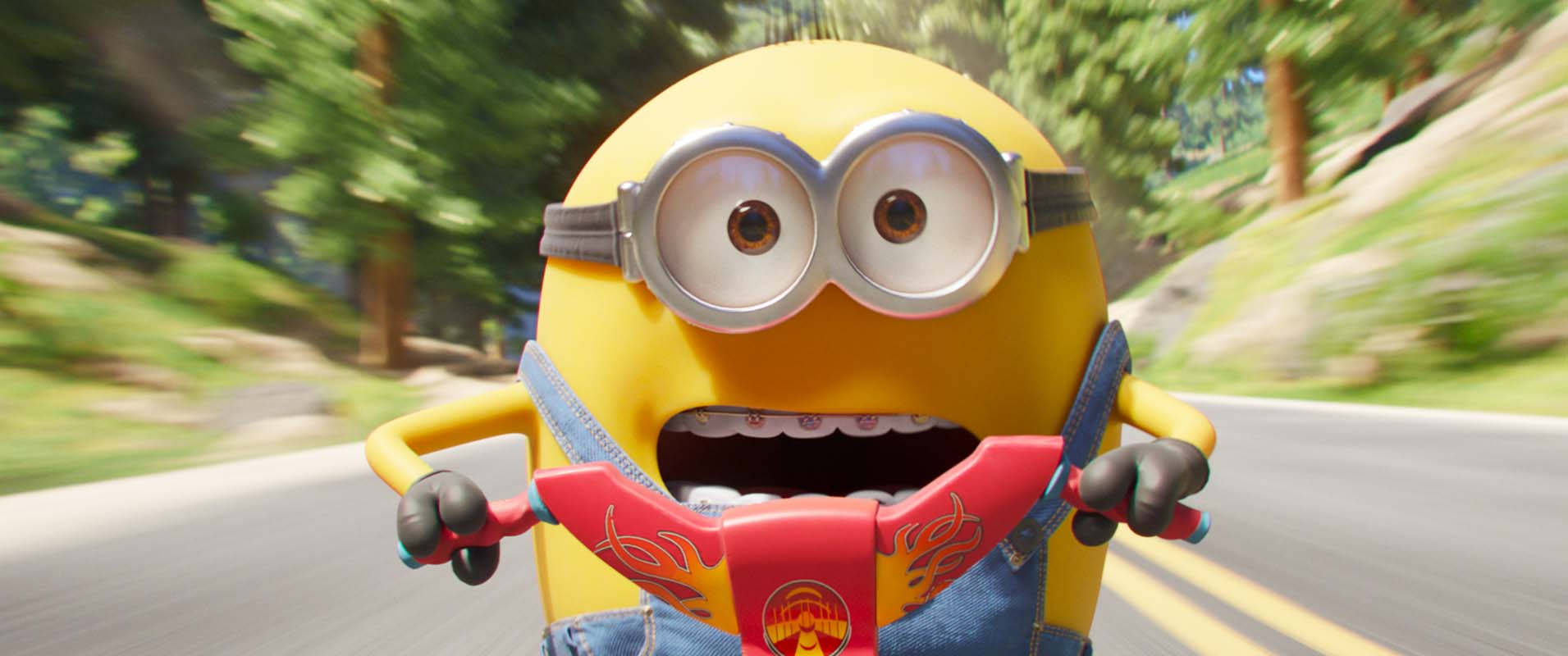 一個黃色嘅Minion揸住紅色滑板車穿過森林，帶有動態模糊效果。