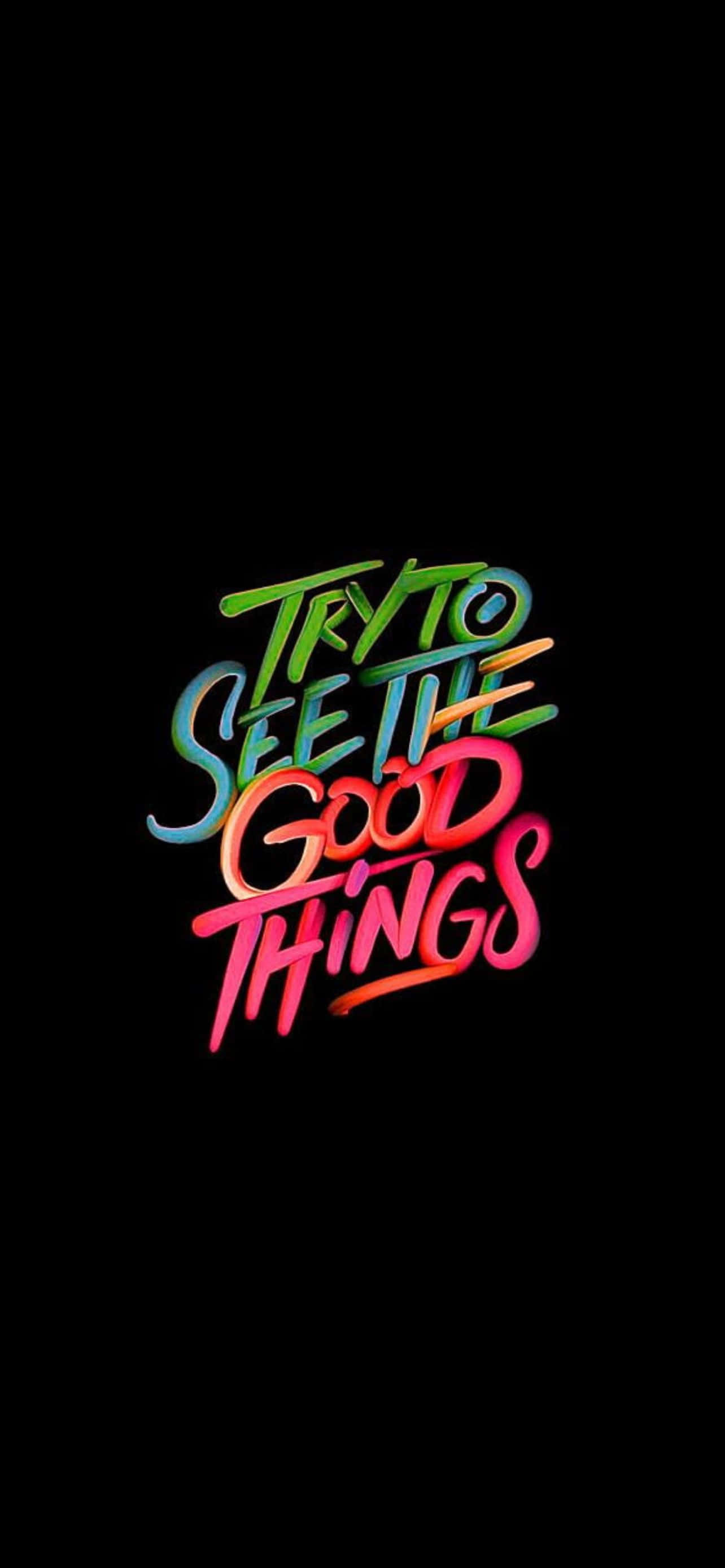 山湖倒映絢麗日落 壁紙 — 鮮豔的霓虹漸變文字「TRY TO SEE THE GOOD THINGS」在純黑背景上發光。