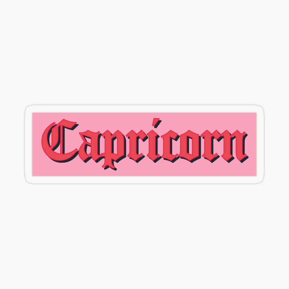 粉紅色貼紙，紅色3D文字寫著Capricorn