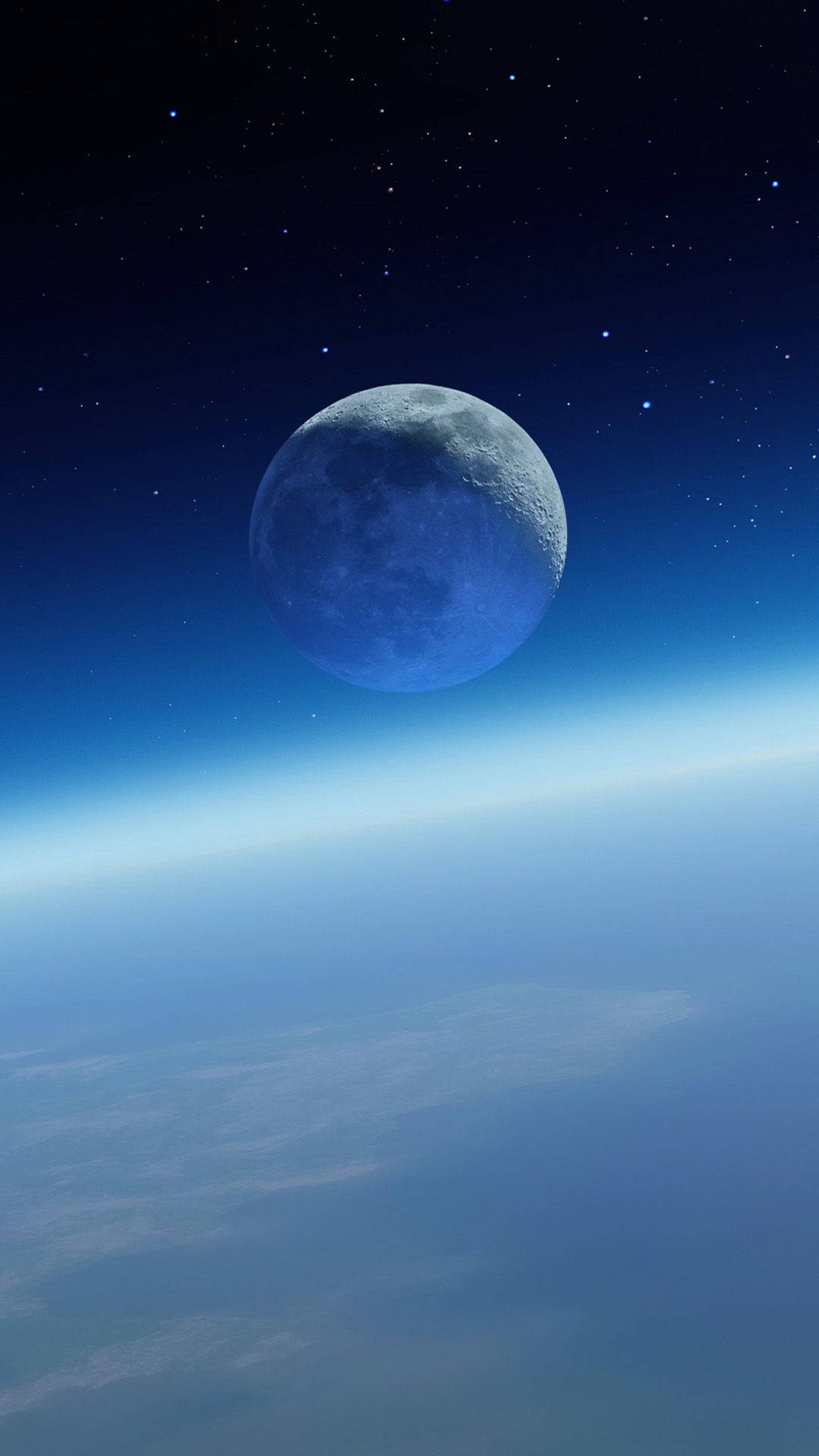 繁星夜空下地球地平線上的藍月