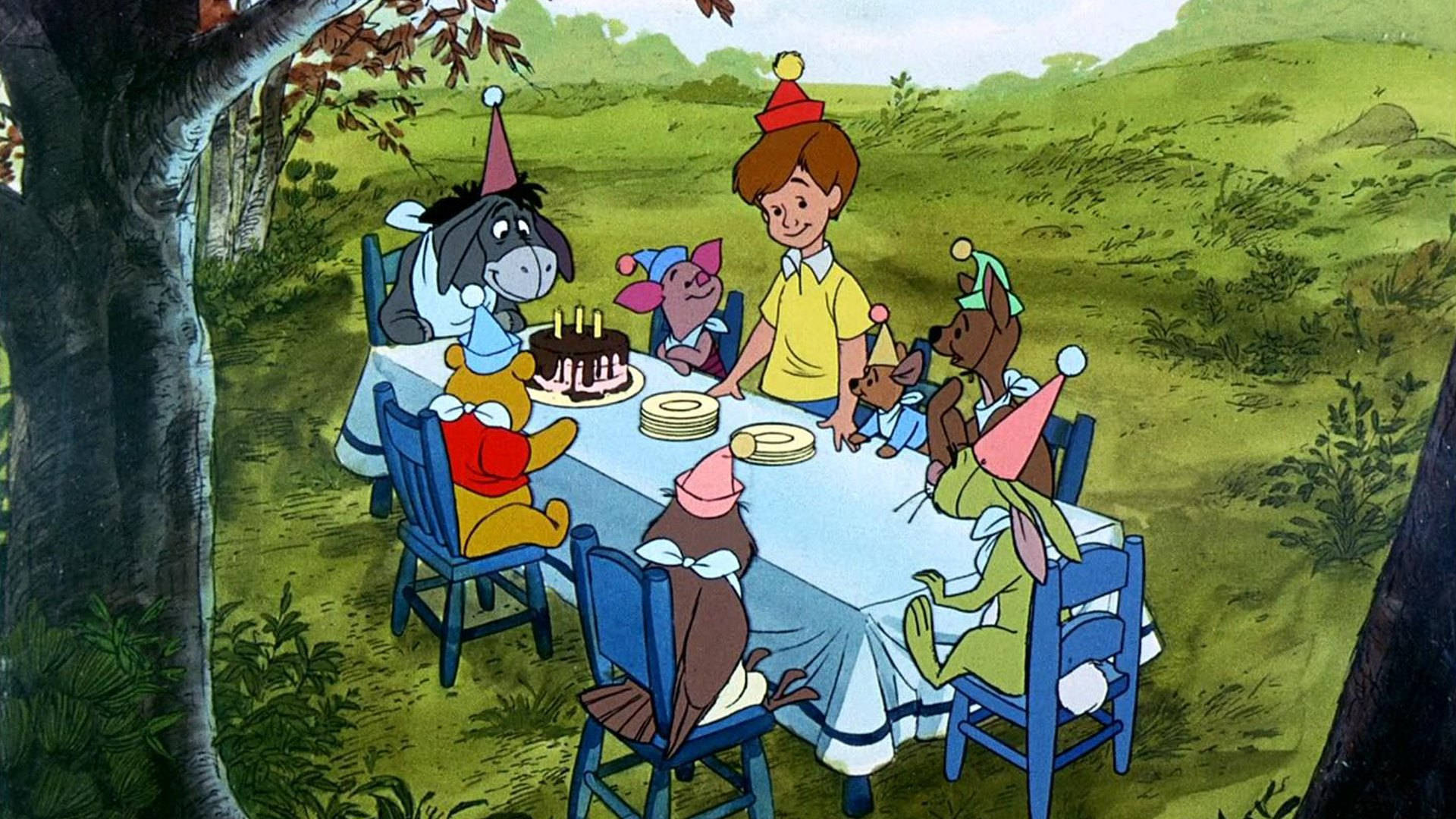 屹耳生日派對 壁紙 — 小熊維尼和朋友們在樹下用朱古力蛋糕和派對帽慶祝生日。