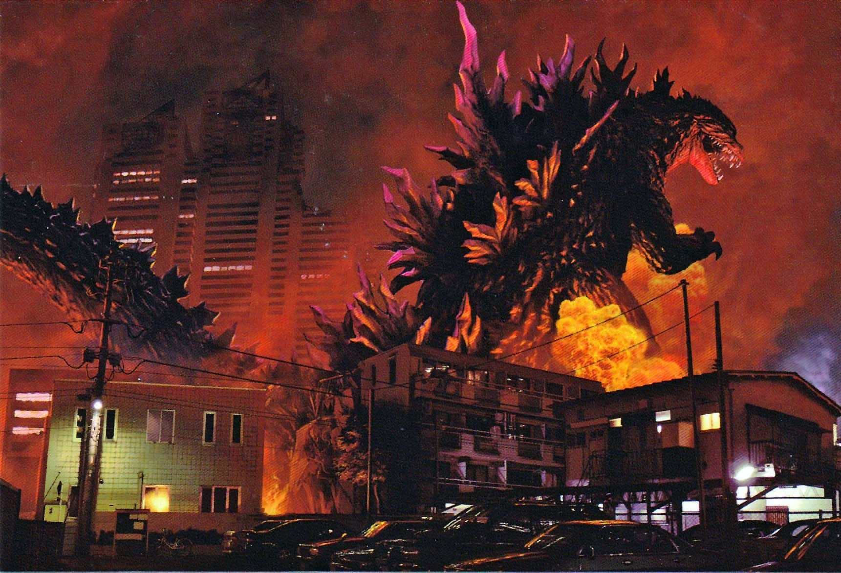 Godzilla 2000 桌布 壁紙 — 巨型哥斯拉在夜晚燃燒的城市景觀中，在烈火毀滅中咆哮。