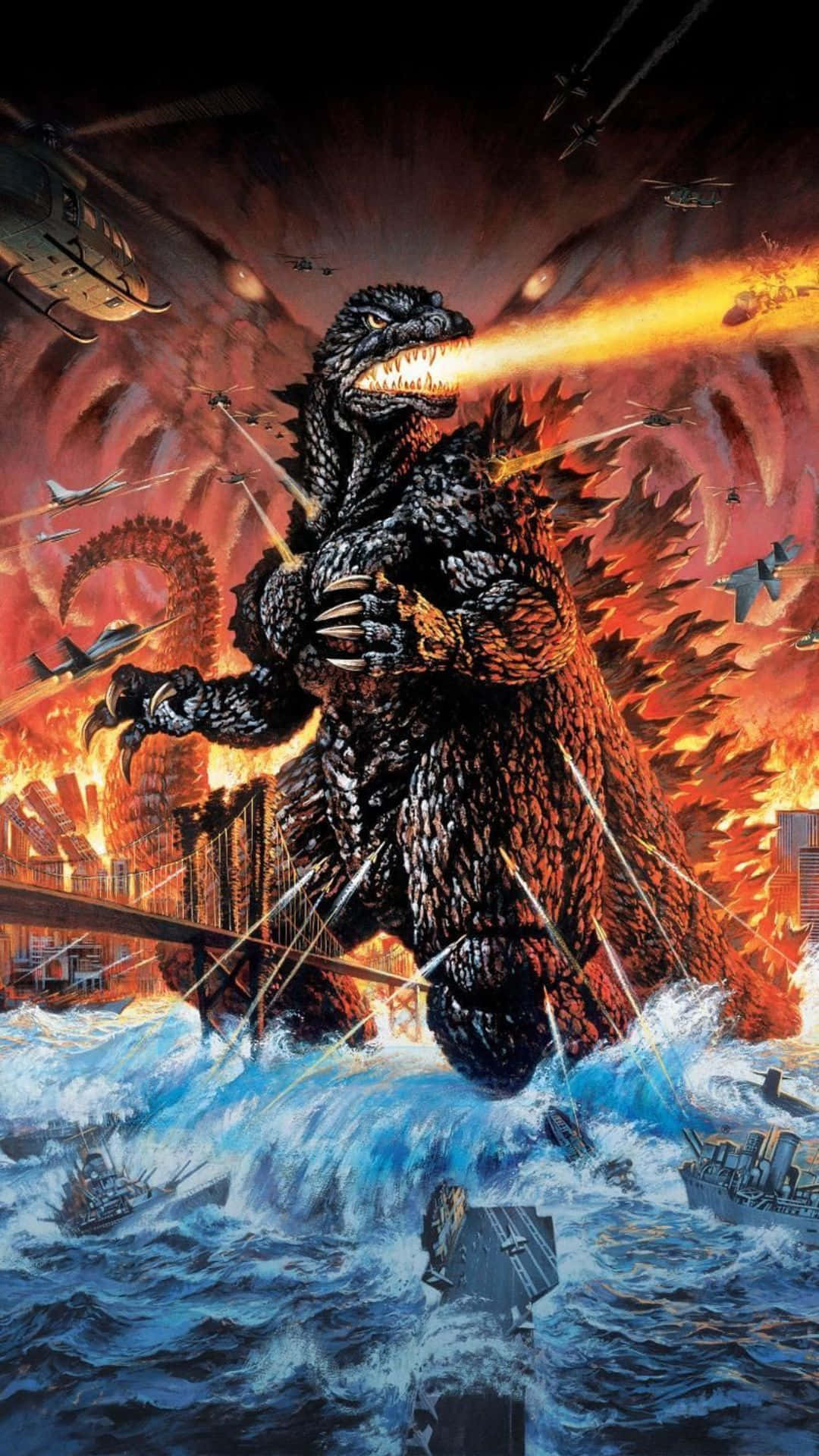 Godzilla 2000 桌布 壁紙 — 巨型哥斯拉從海洋水域中出現，噴射原子火焰，而飛機和直升機在燃燒的城市景觀中攻擊。