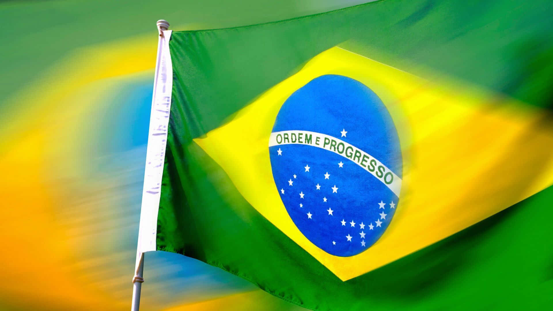 Brazil 桌布 壁紙 — 巴西國旗在綠色、黃色和藍色的模糊漸變背景上動態飄揚。
