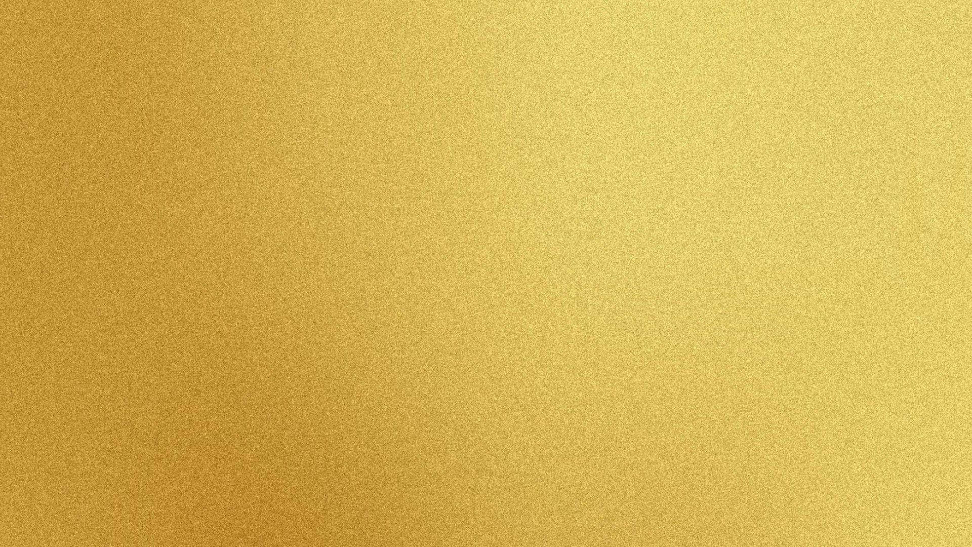 帶有柔和漸變和金屬光澤的金色紋理背景。