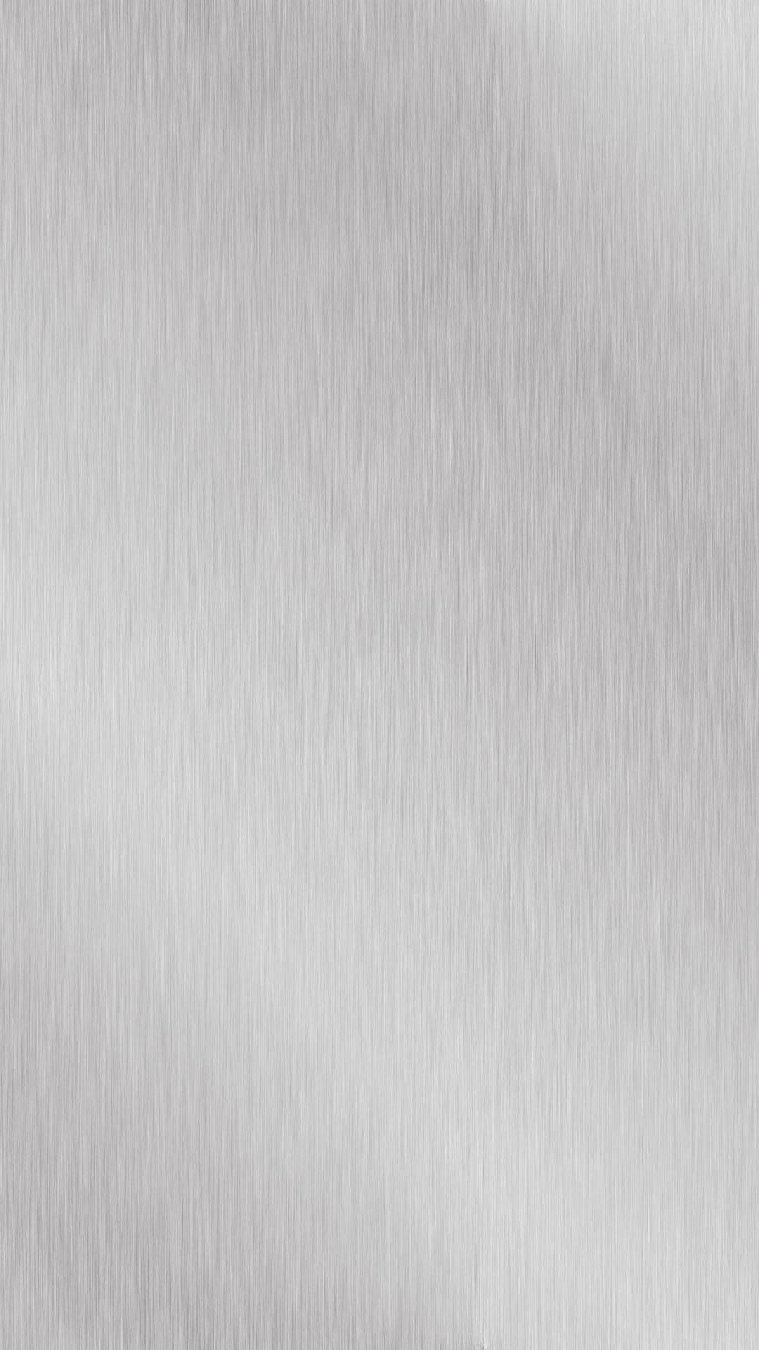 拉絲不鏽鋼表面，具有精細的線性紋理和柔和的光線反射。