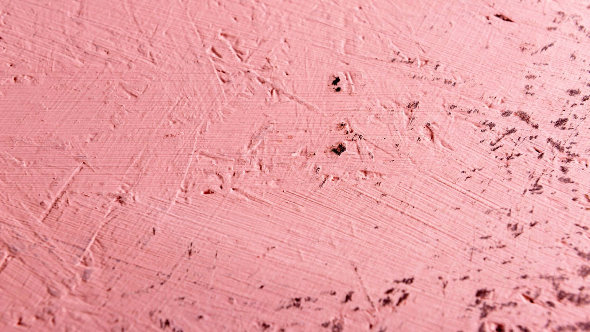 Pink Texture 桌布 壁紙 — 帶有可見筆觸和小黑點的紋理粉紅色油漆表面特寫。