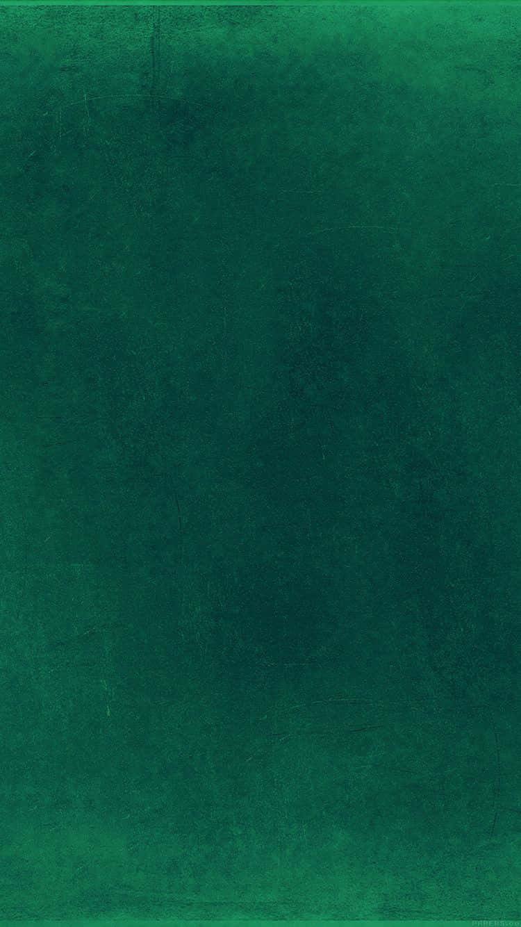 翡翠綠 桌布 壁紙 — 帶有微妙漸變和輕微刮痕的紋理深綠色抽象背景。