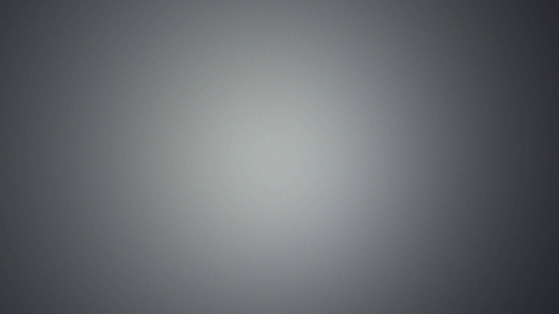 柔和灰色漸變背景，淺色中心漸變至深色邊緣。