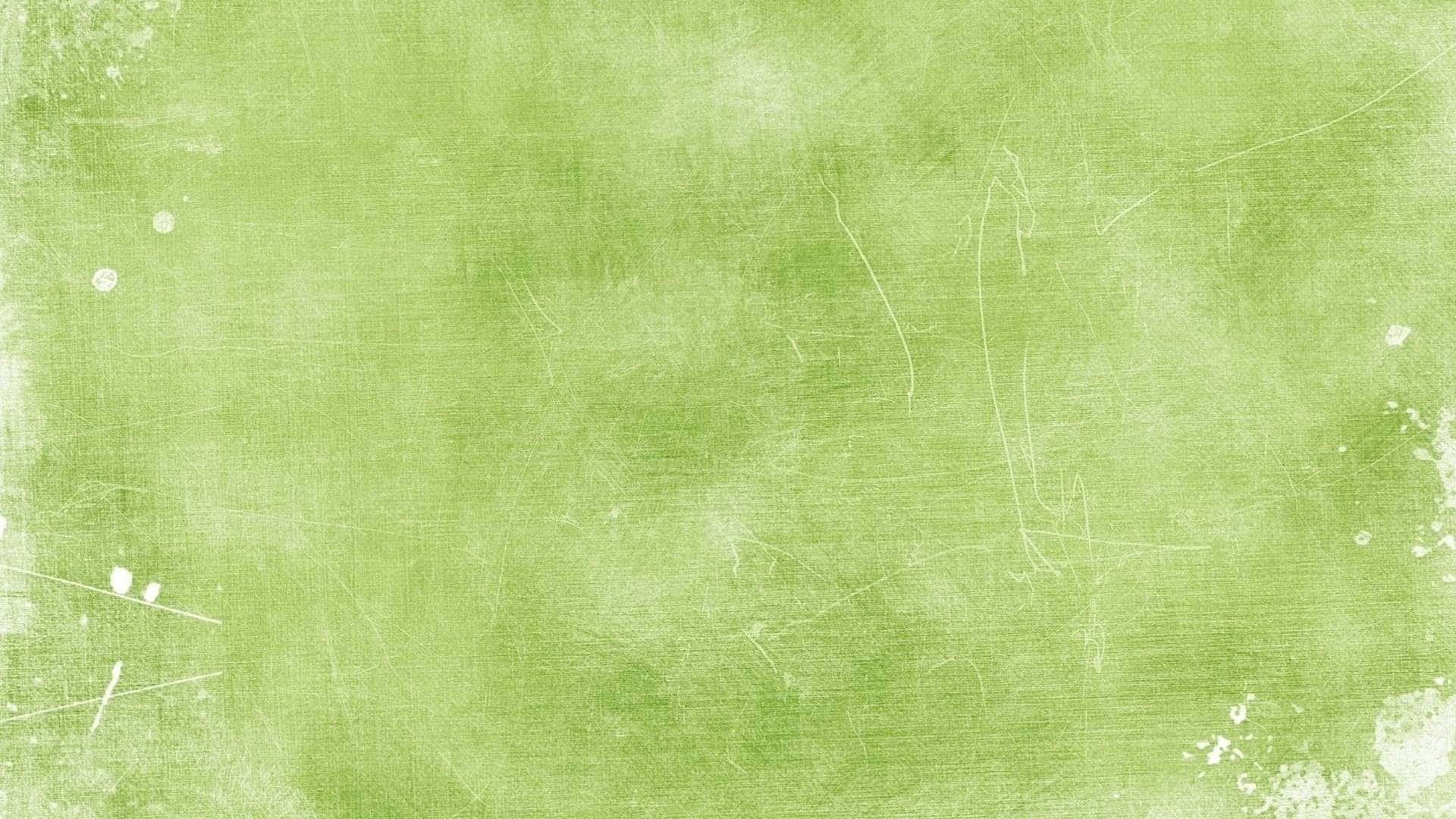 Green Texture 桌布 壁紙 — 帶有細微刮痕和白色斑點的紋理淺綠色背景，營造出復古磨損效果。