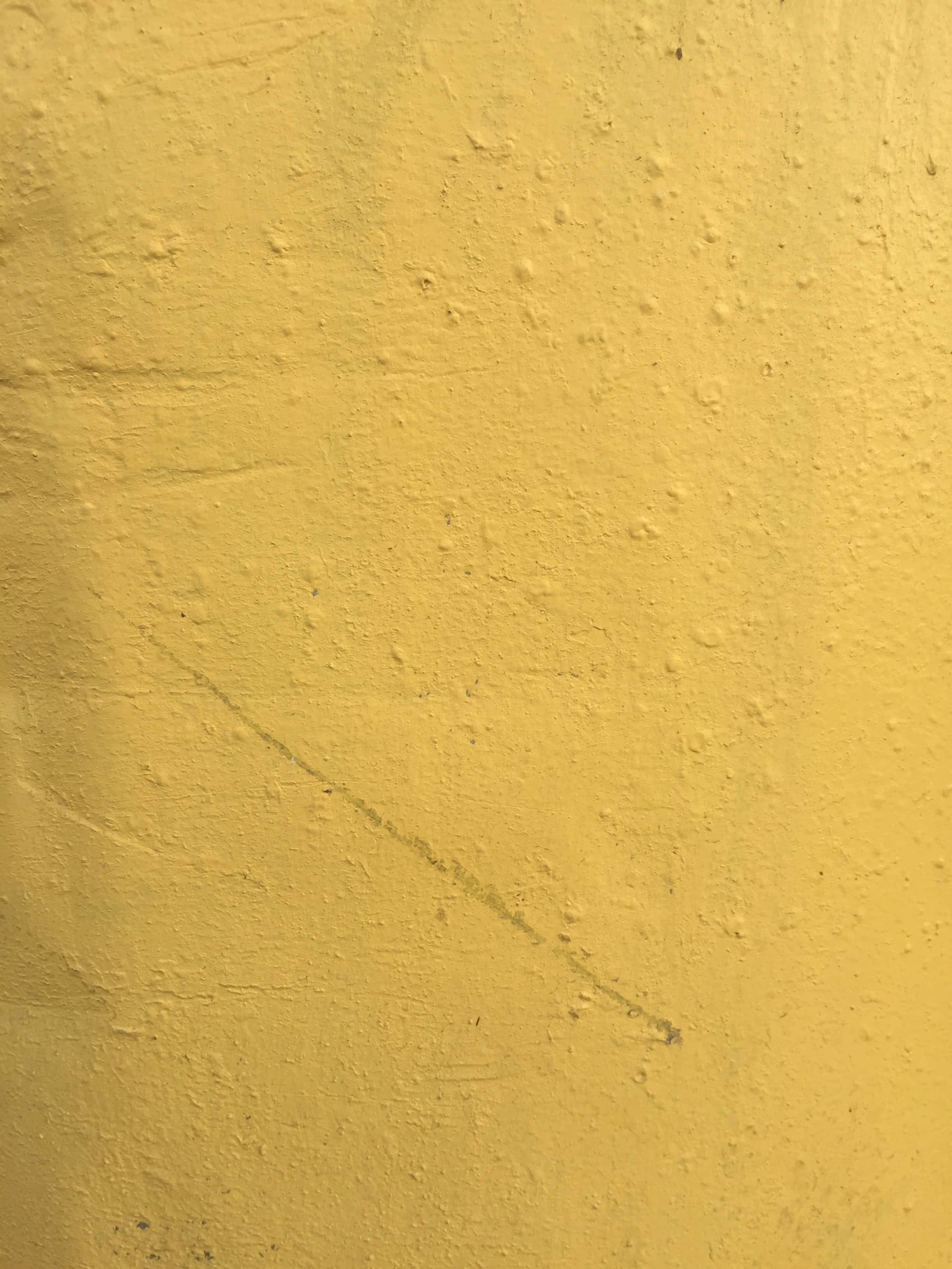 Paint Texture 桌布 壁紙 — 帶有細微瑕疵和微弱對角線刮痕的紋理黃色牆壁特寫。