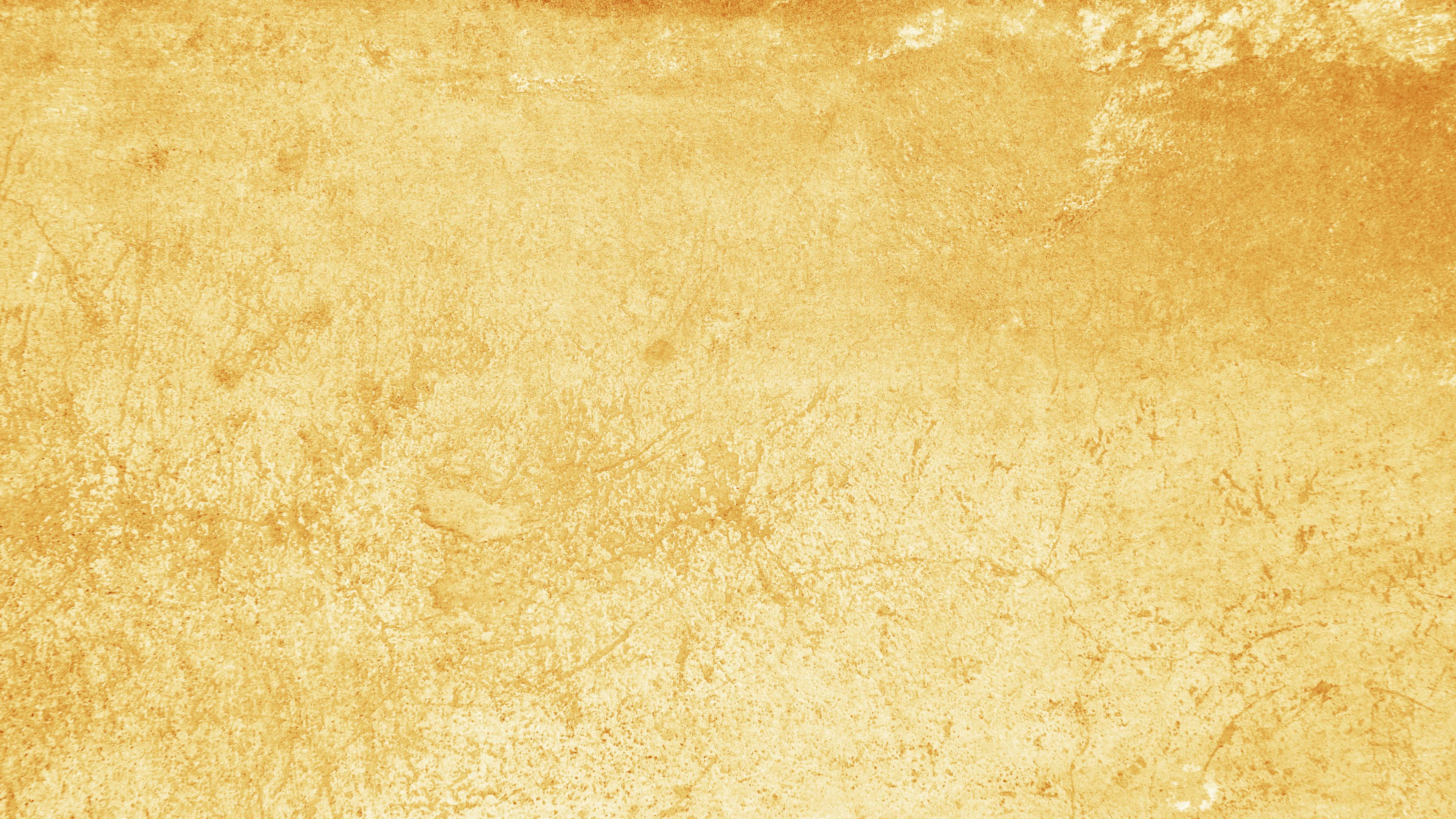 Yellow Grunge 桌布 壁紙 — 帶有細微裂紋和不均勻表面細節的紋理金黃色牆壁。