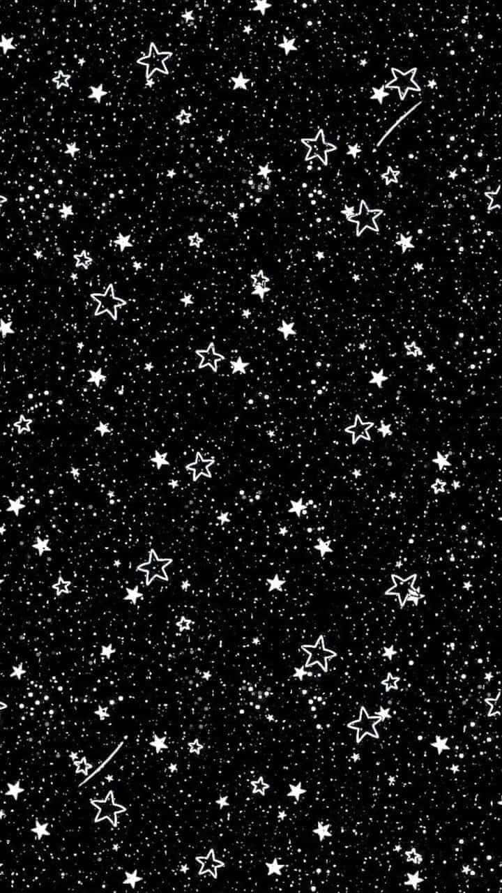 黑色背景上有白色輪廓星星和流星。