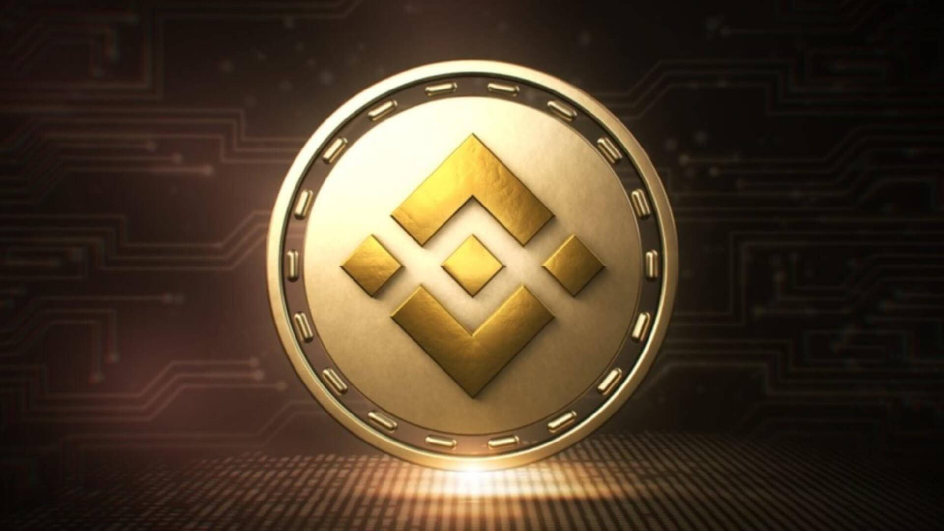 幣安金屬盾牌 壁紙 — 一枚閃閃發光的金色Binance硬幣放在電路板表面上，背景有發光的數位線條。