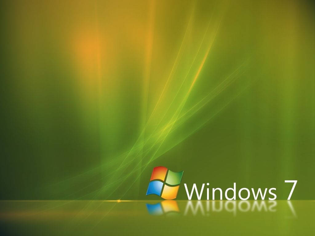平滑綠色Windows Vista 壁紙 — Windows 7 標誌在帶有光線條紋的綠色漸變背景上發出彩色反射的光芒。