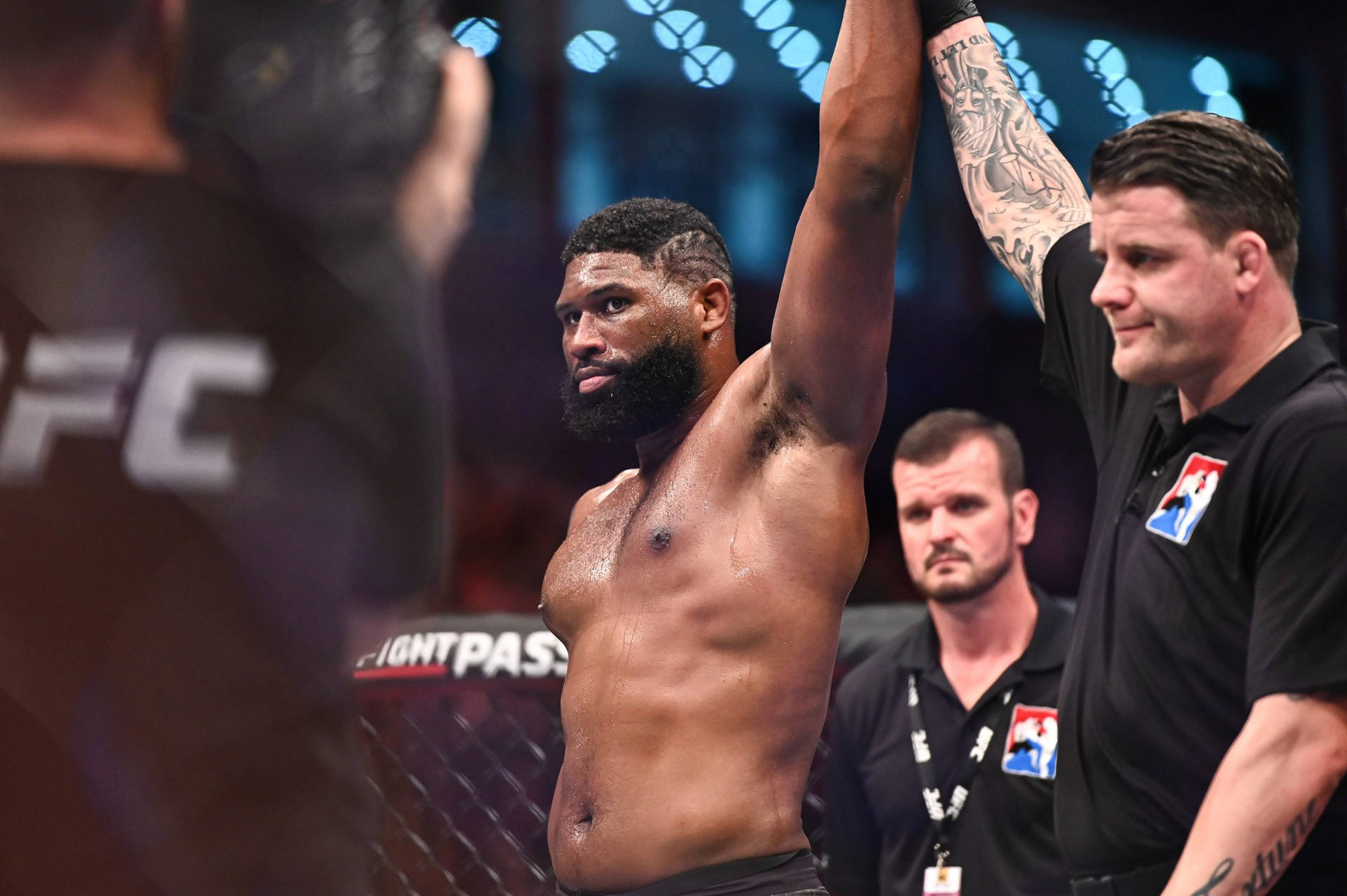 UFC拳手在八角籠中被裁判舉起慶祝勝利