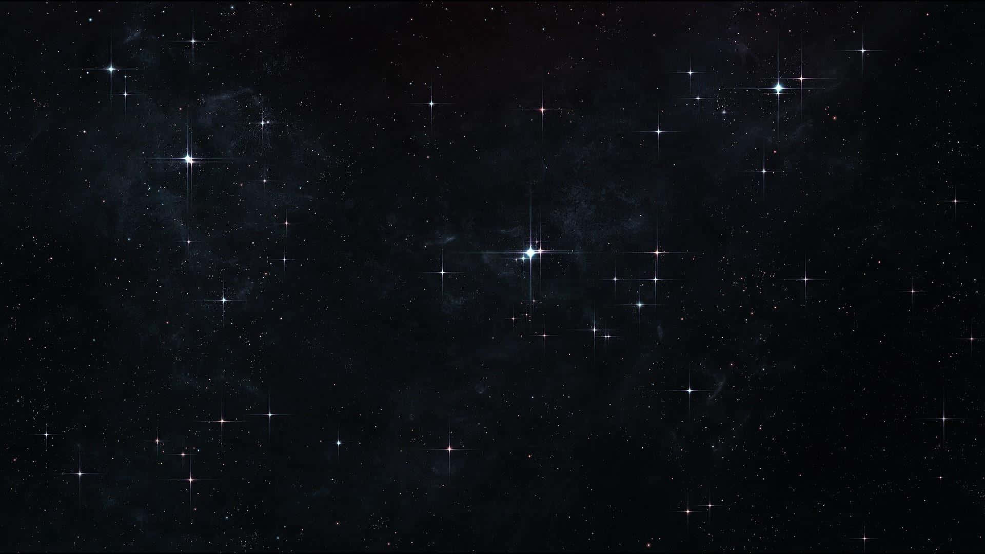 星空 桌布 壁紙 — 廣闊的宇宙空間，充滿了閃爍的星星和微妙的星雲，在深邃的黑色虛空中發光。