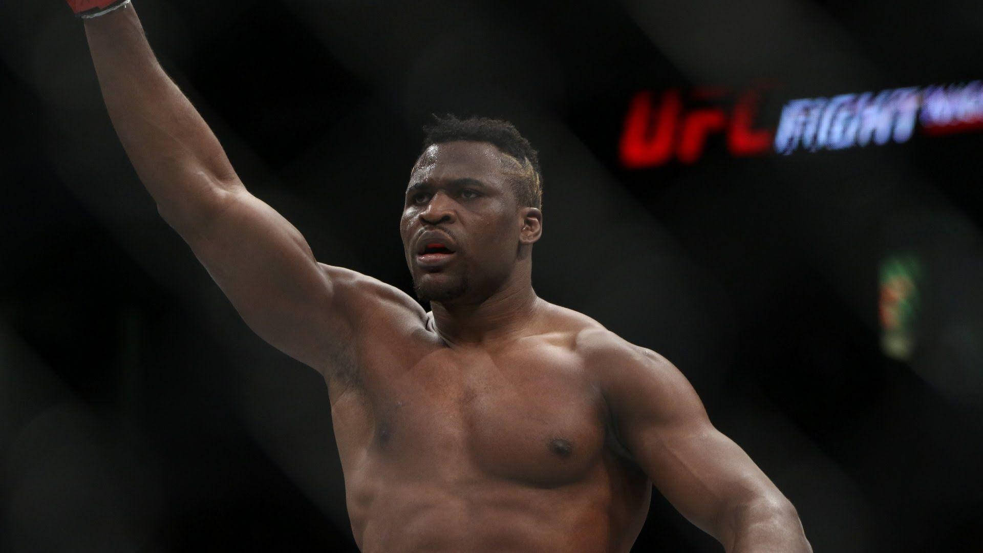 UFC拳手在八角籠內舉臂慶祝勝利。
