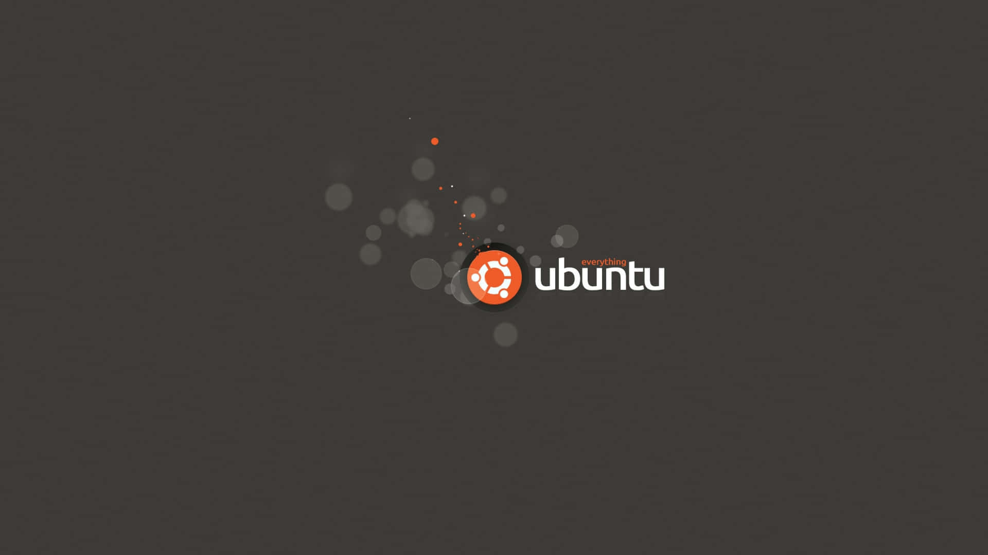 Ubuntu 標誌，橙色圓圈和白色文字在深灰色背景上，帶有發光粒子。