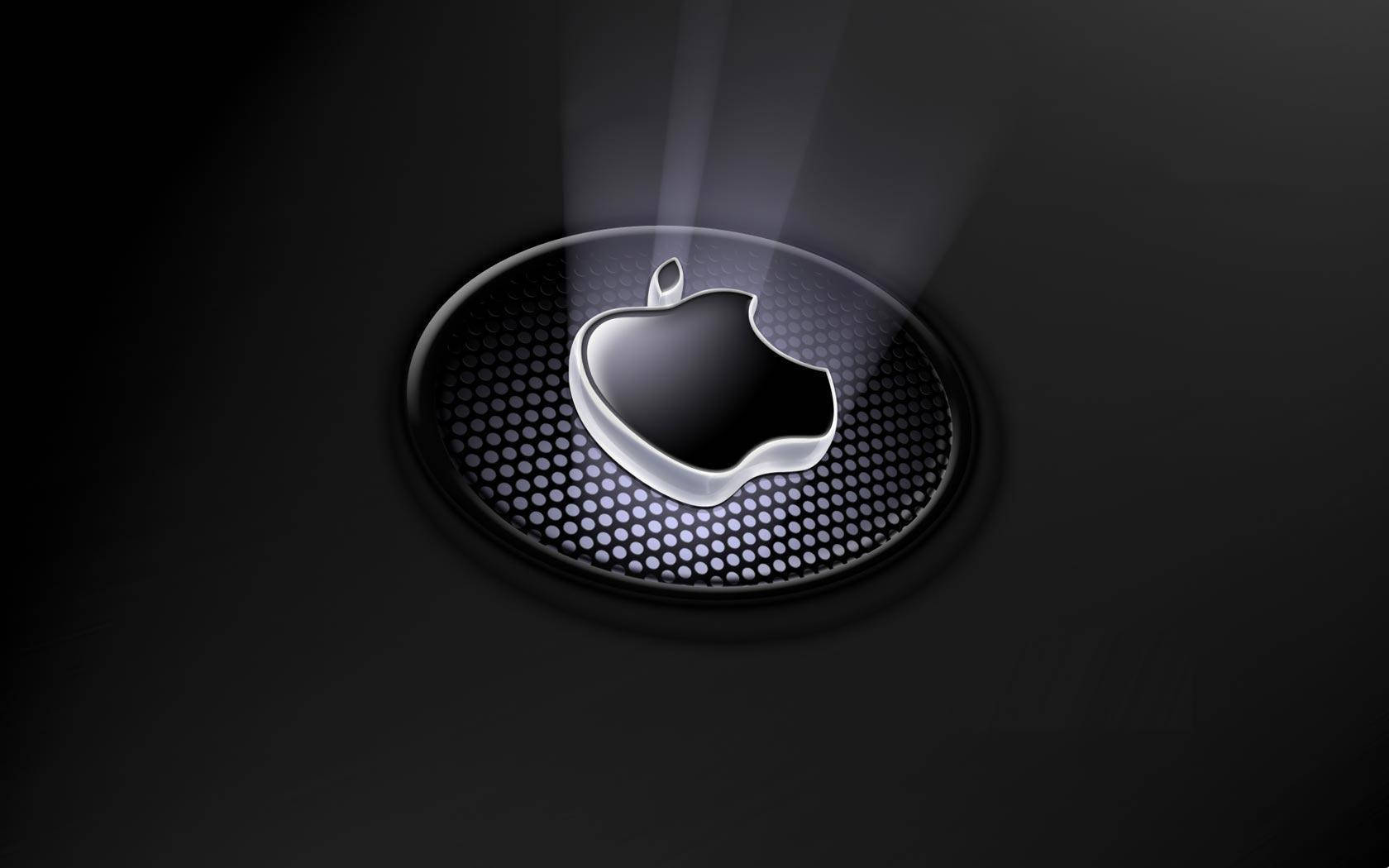 閃亮的Apple標誌在黑暗穿孔表面上發出光束