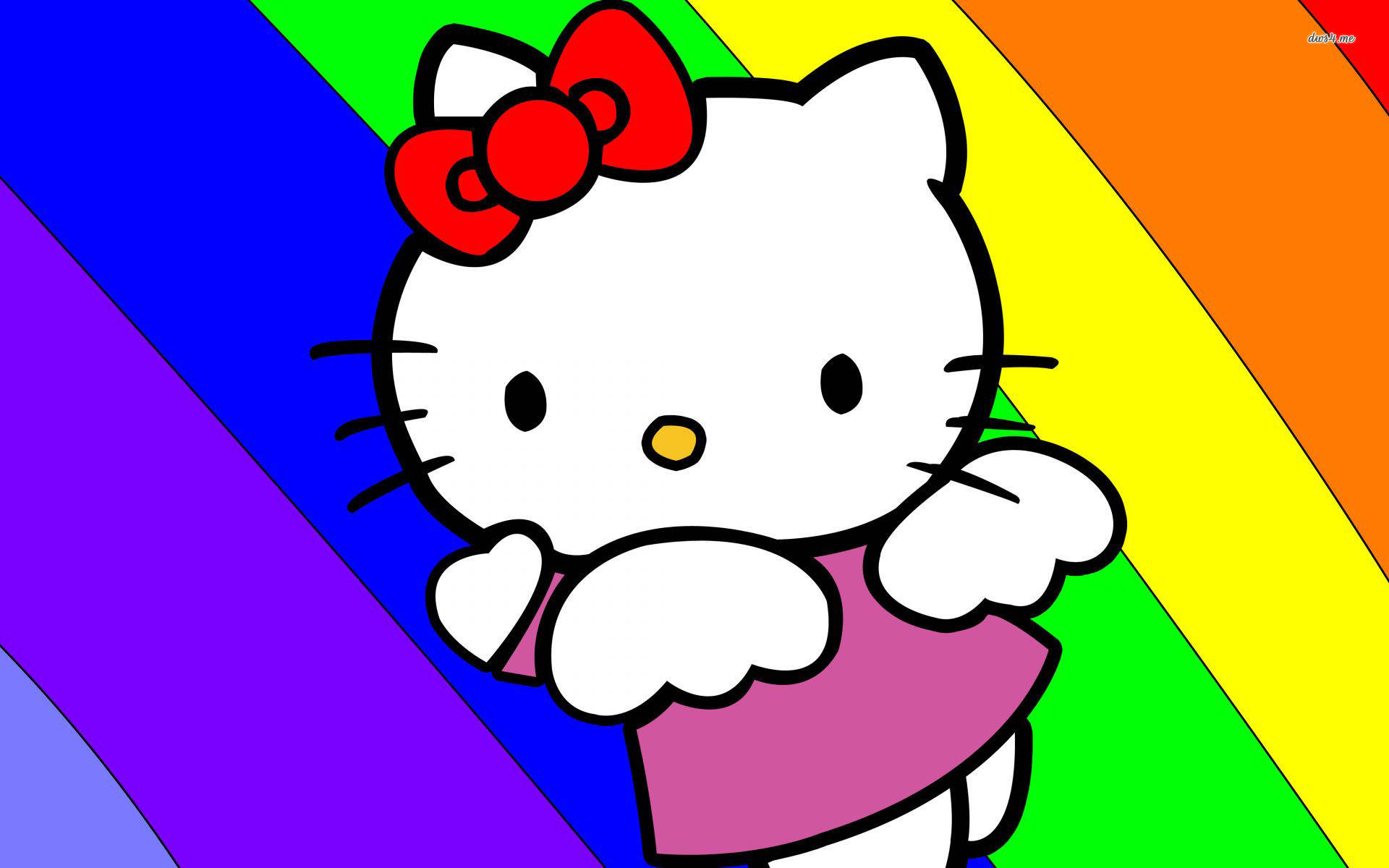彩虹Hello Kitty桌面壁紙 壁紙 — Hello Kitty 身穿粉紅色連衣裙，戴著紅色蝴蝶結，站在充滿活力的彩虹對角線背景前。