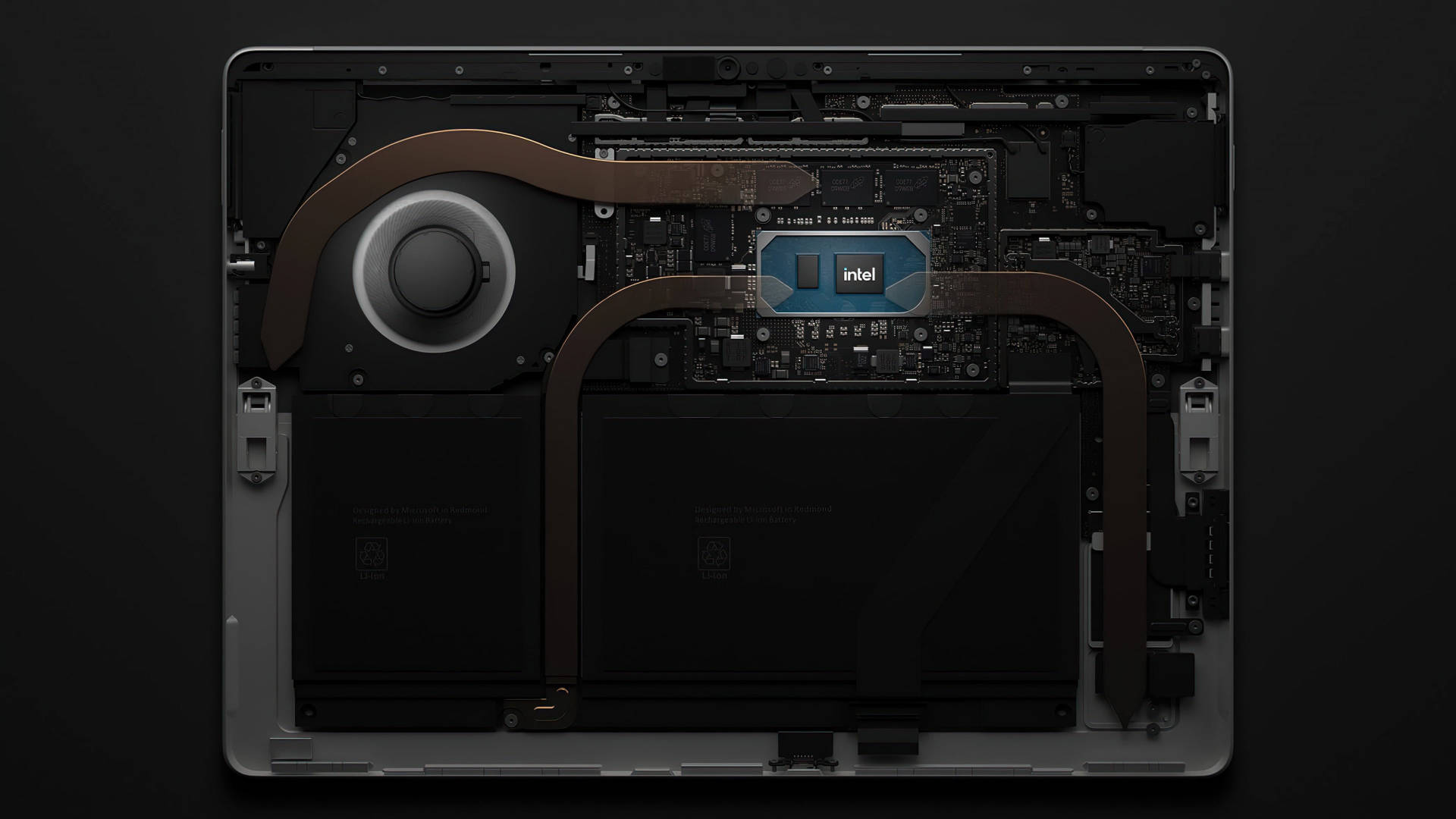 microsoft 桌布 壁紙 — 從上方俯瞰筆記型電腦內部組件，包括 Intel 晶片冷卻系統和電池，背景為深色。