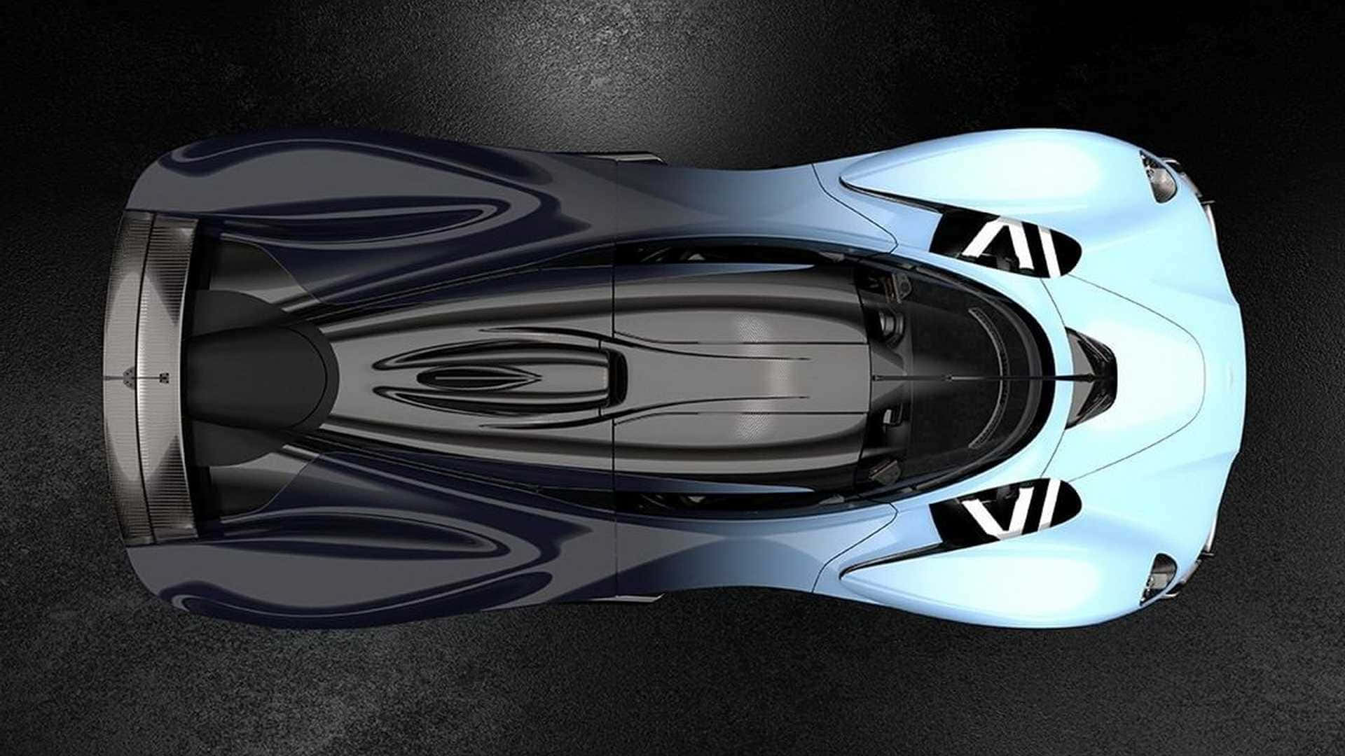Aston Martin Valkyrie 桌布 壁紙 — 從上方直接觀看，在深色紋理表面上，一輛時尚的未來主義跑車，帶有漸變藍色和黑色飾面。