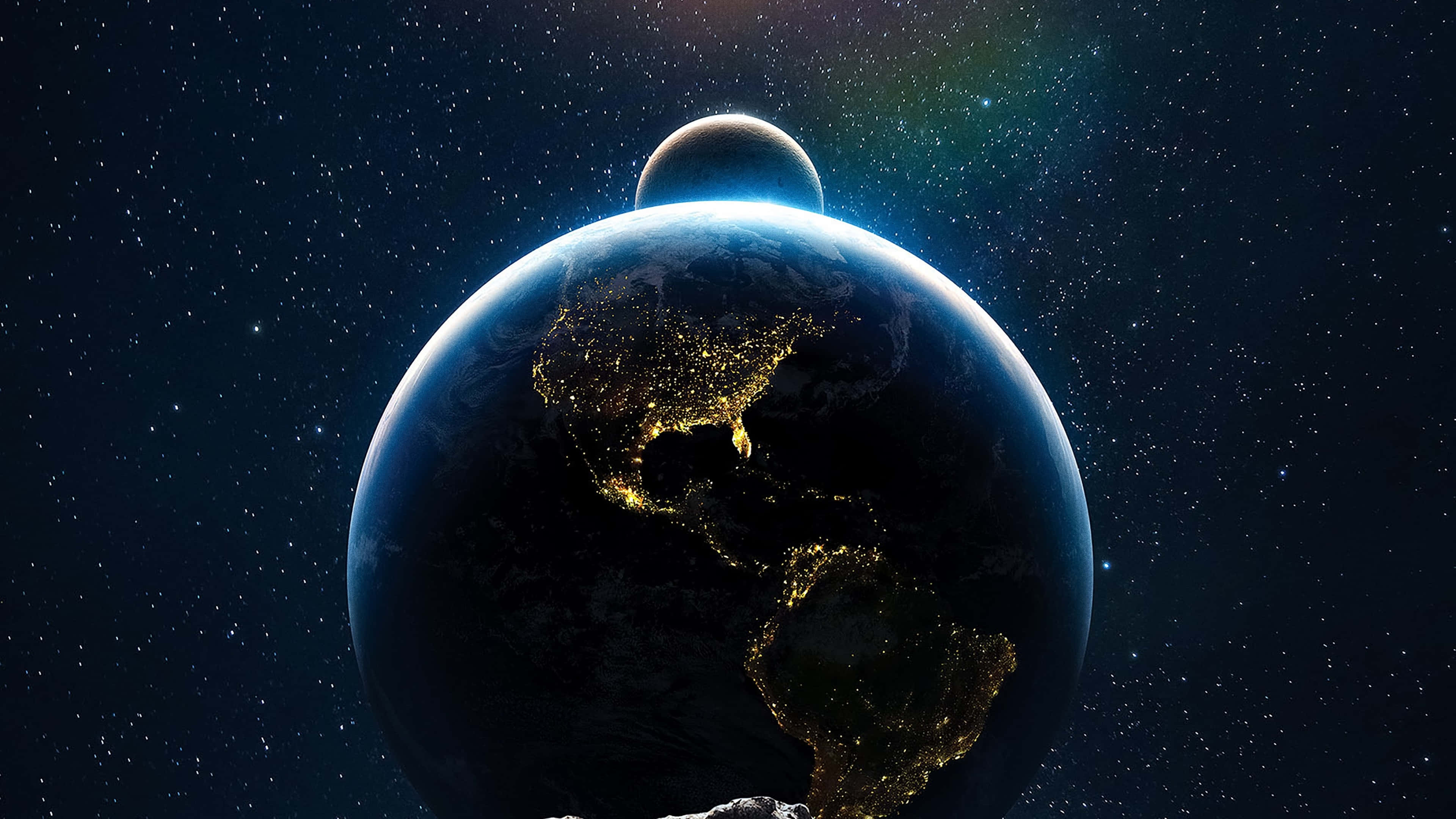 從外太空觀看地球的壯麗景色 壁紙 — 從太空俯瞰地球的壯麗景色，北美洲和南美洲上空閃爍的城市燈光，背景中有一輪月亮。