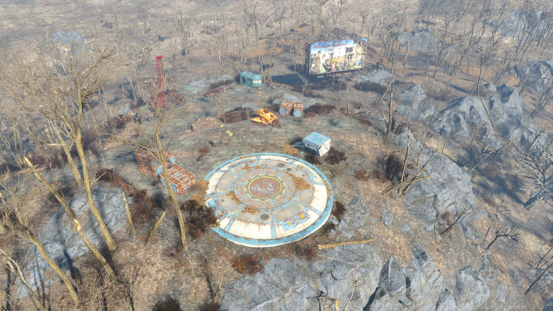 Fallout 4 Vault 桌布 壁紙 — 從空中俯瞰一個圓形、風化的結構，位於荒涼貧瘠的荒地，有枯樹和散落的碎片。