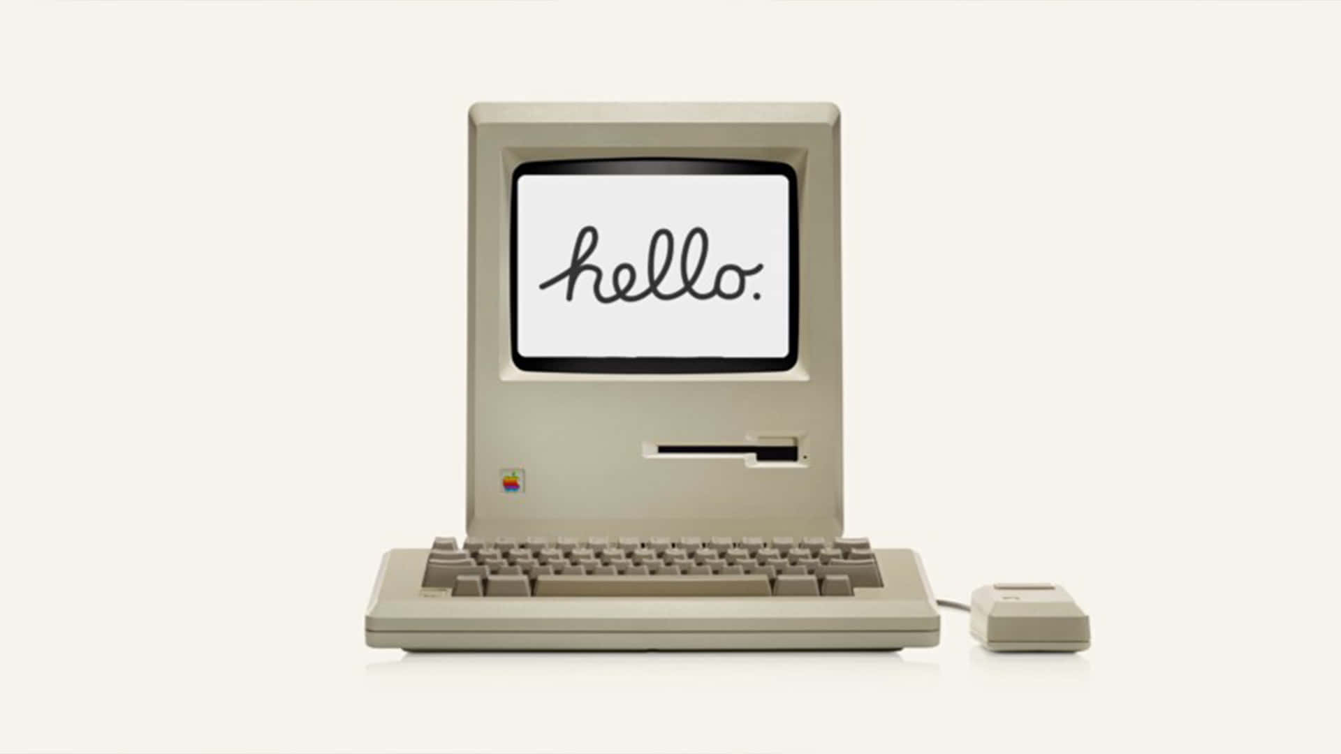 Hello 桌布 壁紙 — 復古米色 Macintosh 電腦，屏幕上以草書顯示 'hello.'，背景簡潔。