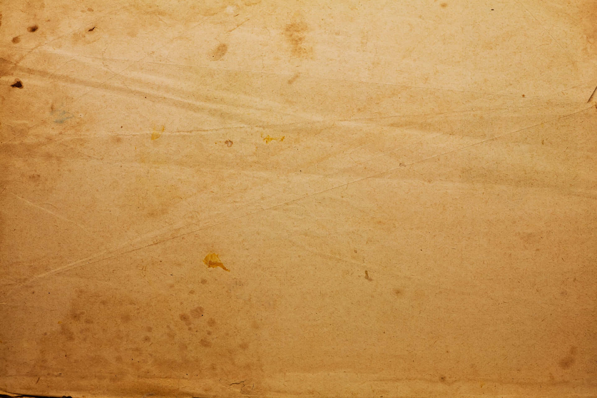 帶有摺痕和污漬的復古米色紙張特寫。