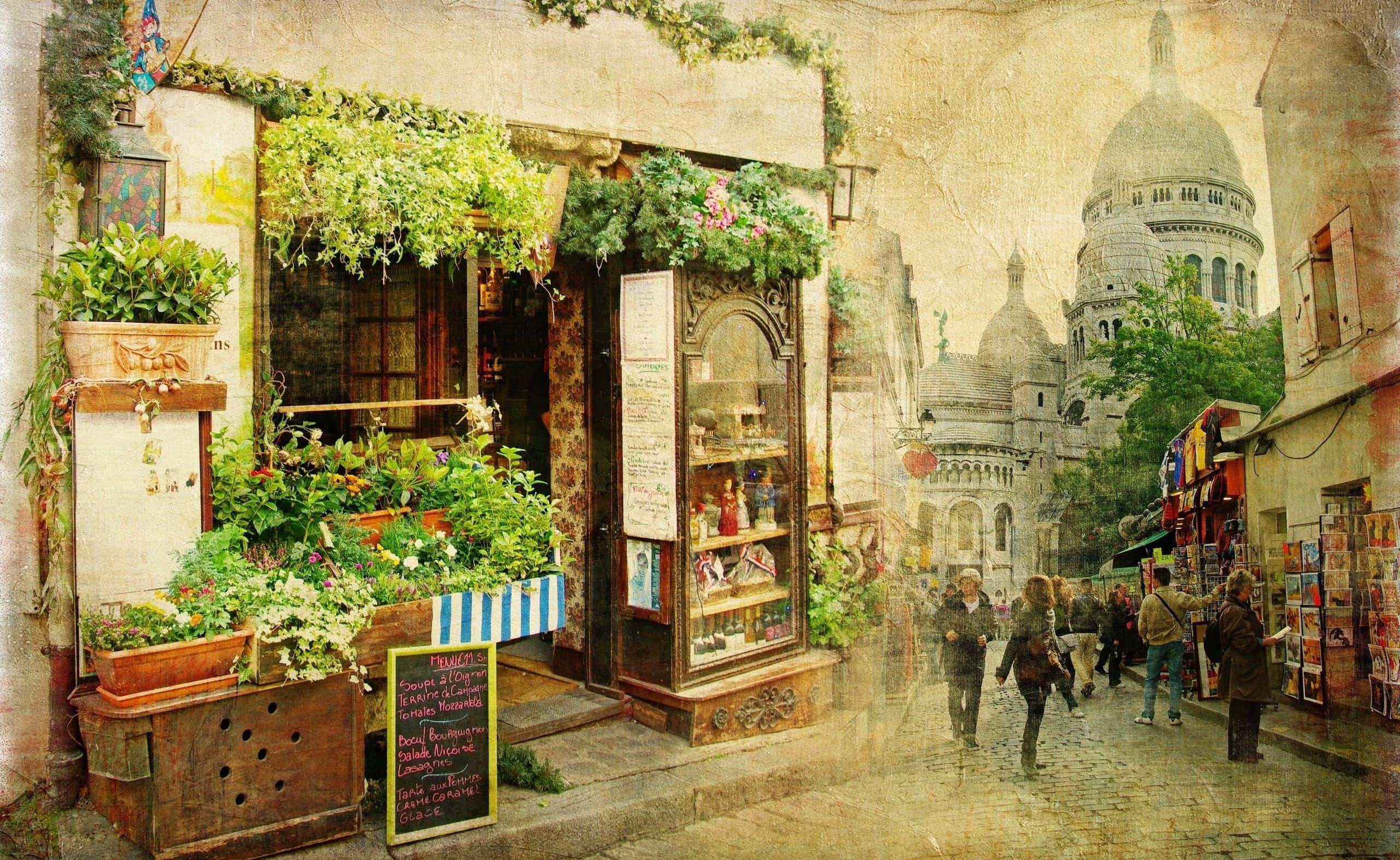 復古風格桌面商店 壁紙 — 迷人的巴黎街景，花店櫥窗滿佈鮮花，遠處的聖心大教堂在溫暖的金色光芒下。