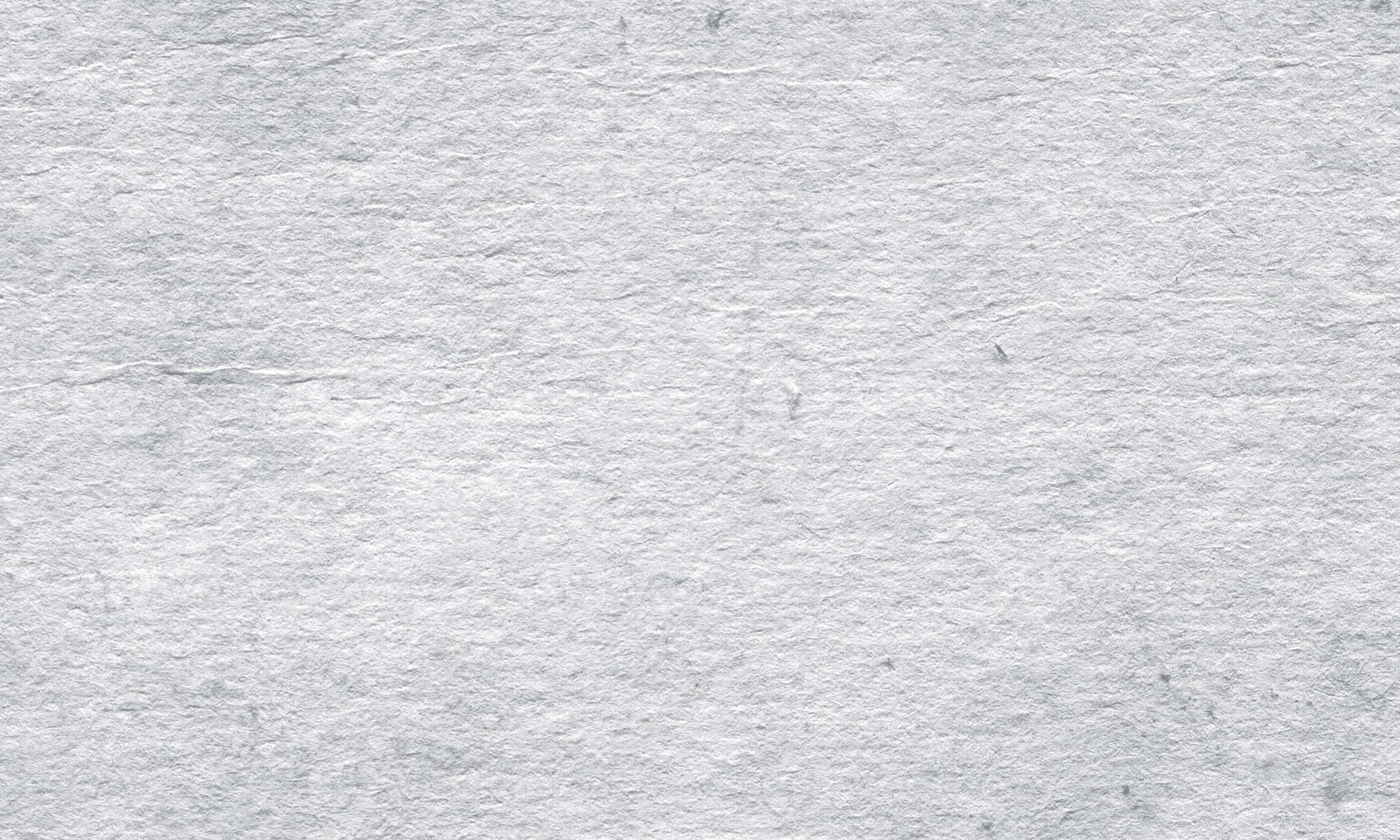 白色紋理紙張的特寫，帶有細微的灰色摺痕和淡淡的斑點。
