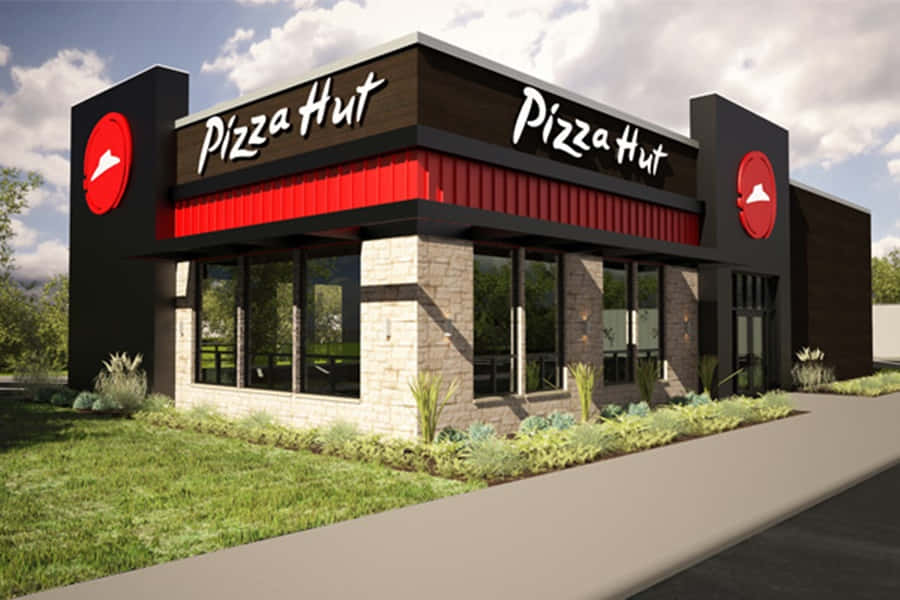 Pizza Hut餐廳，紅黑外觀和石牆。