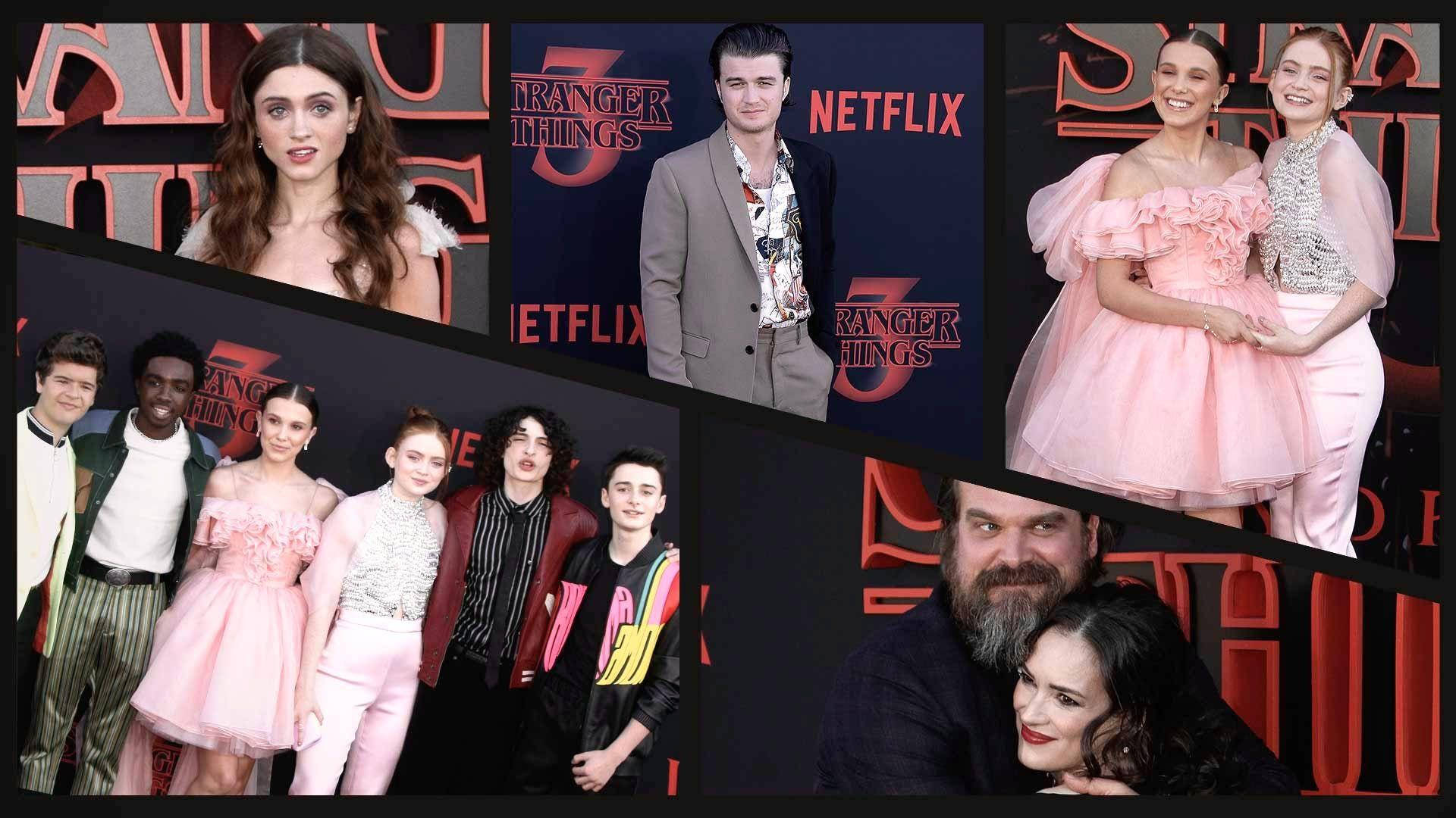 《怪奇物語》演員在 Netflix 活動中於紅色品牌背景前擺姿勢。
