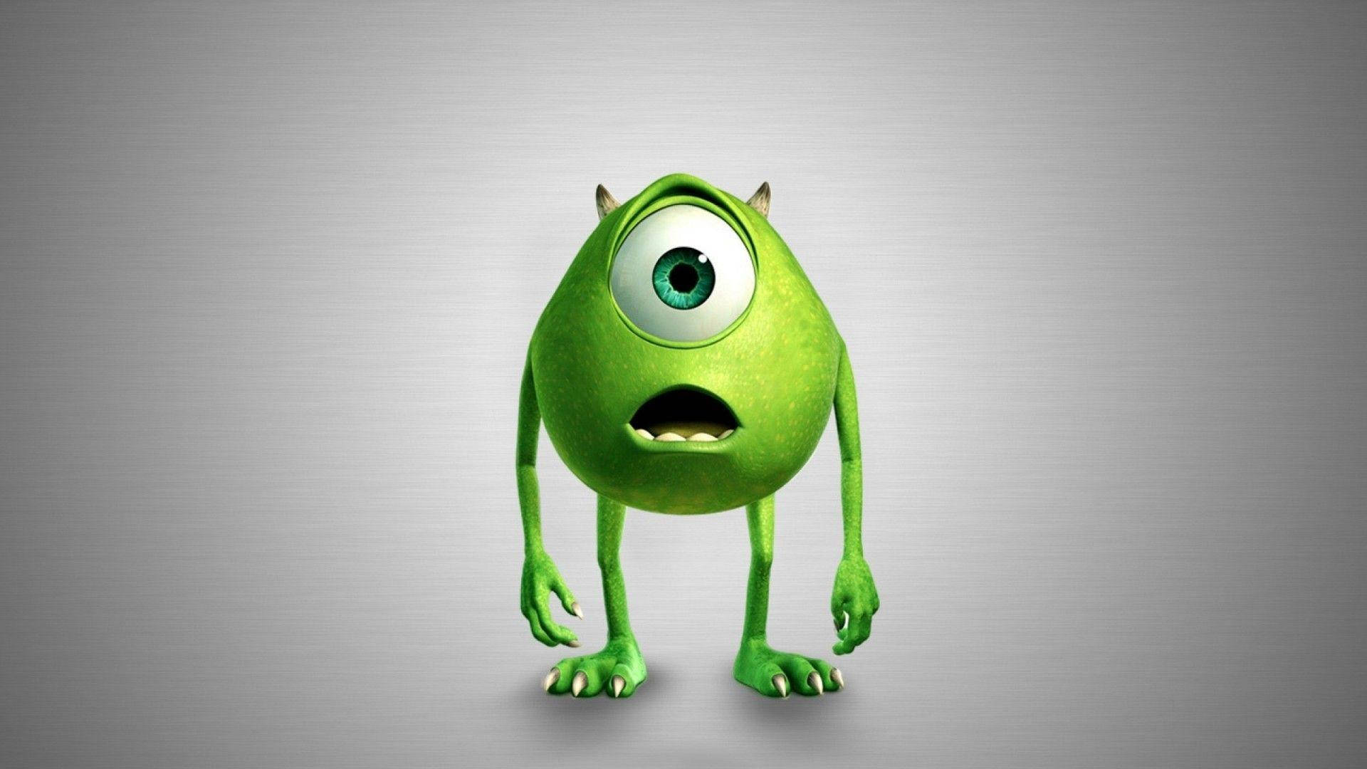 《怪獸大學》驚訝 Mike Wazowski 壁紙 — 一個有角同爪嘅大綠色眼怪獸企喺普通灰色背景前面。