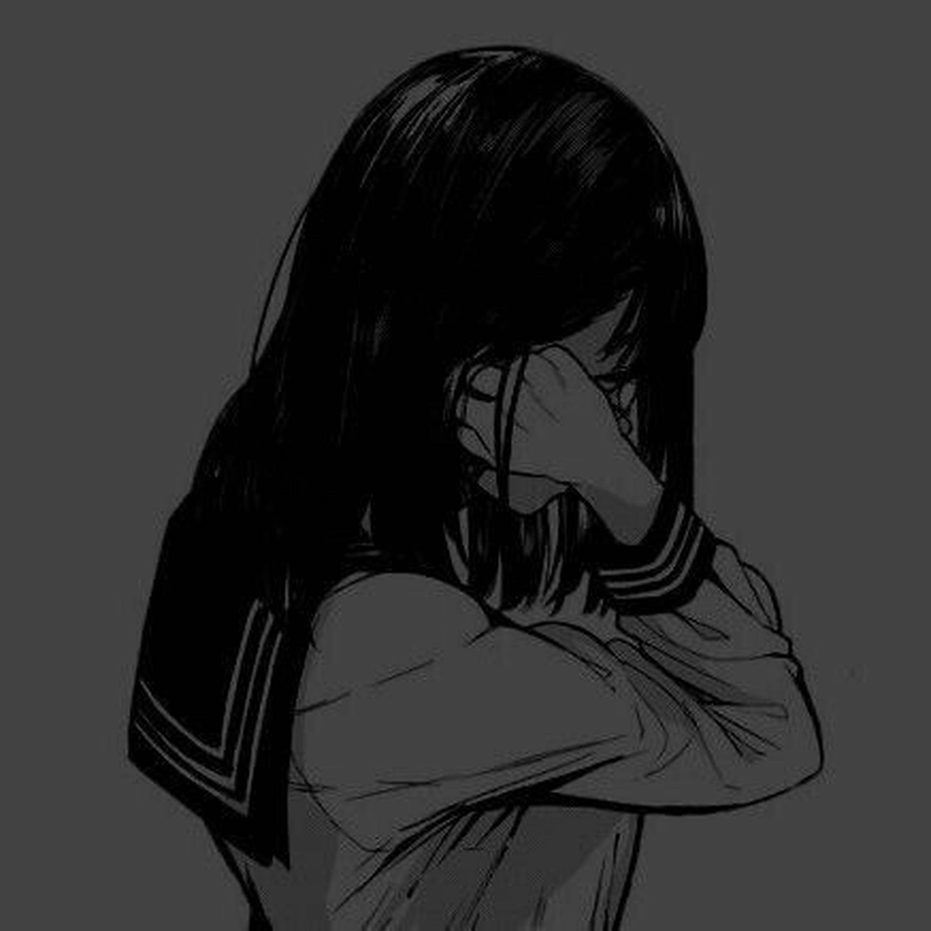 一個穿著水手服的悲傷動漫女孩用手遮住臉。