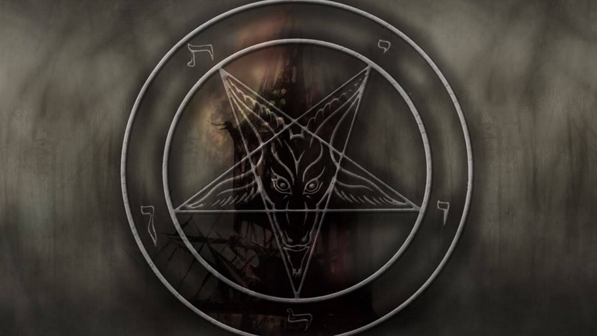 一個在混凝土牆上畫的五角星內的山羊頭惡魔。