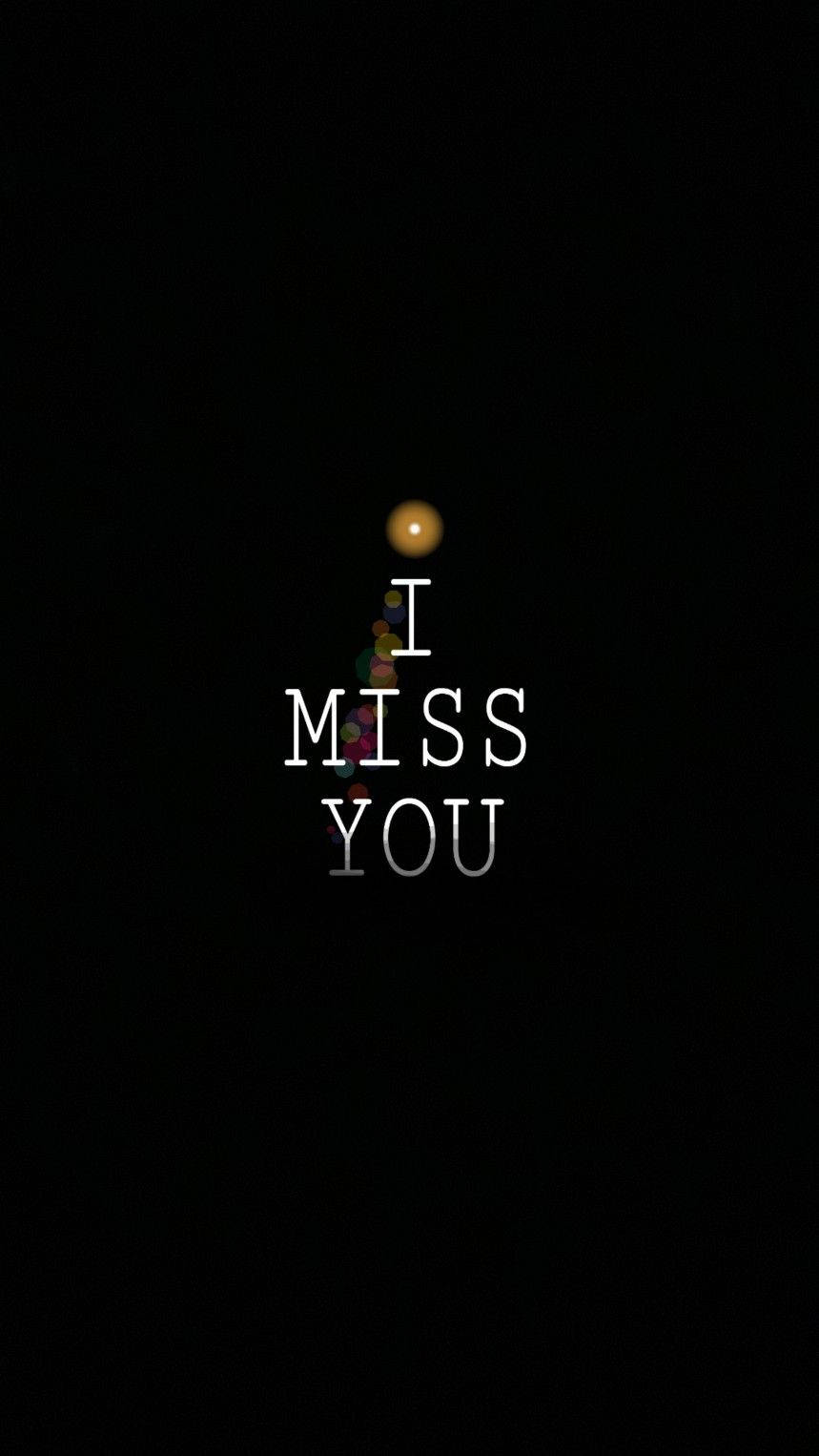 想念你 模糊光斑 壁紙 — 一個極簡的黑色背景上，白色文字顯示「I MISS YOU」，上方有一個發光的球體，傳達思念之情。