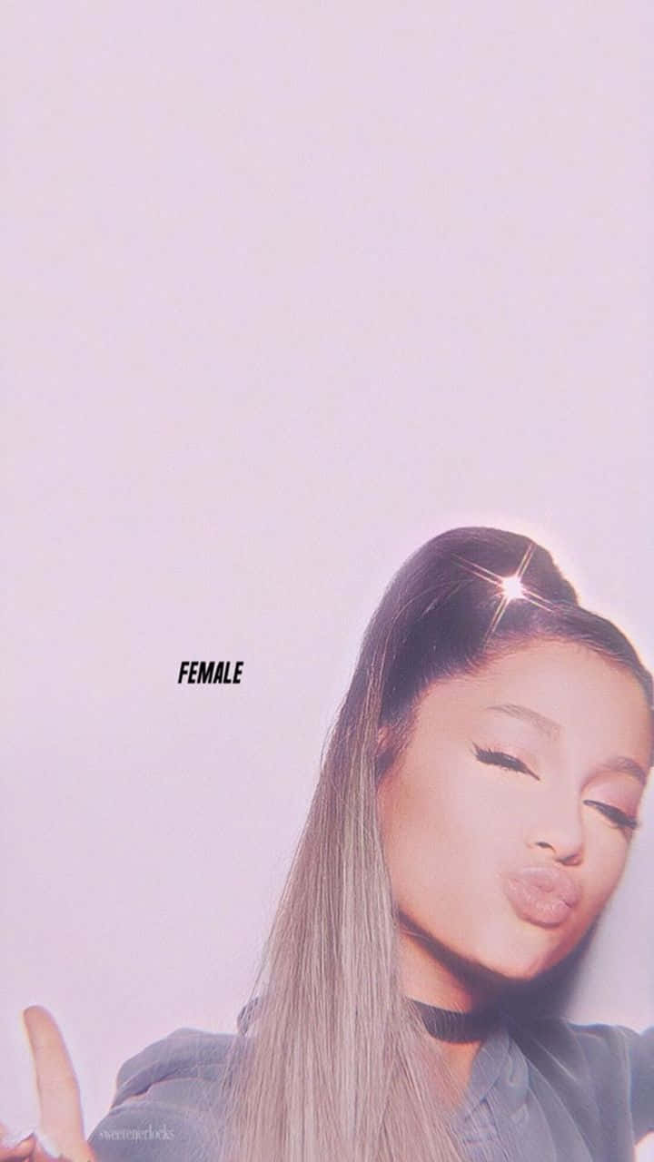 Ariana Grande 眨眼嘟嘴，帶有星爆光芒，在紫色燈光的自拍中。