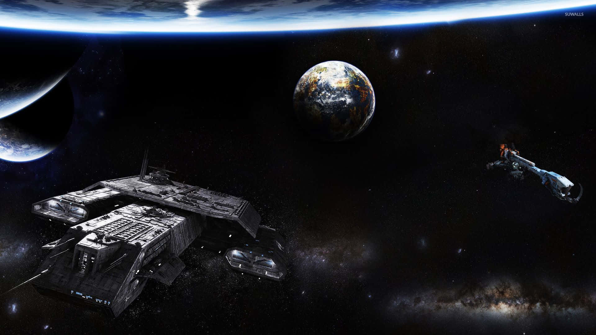 兩艘太空船在一個充滿星星的星系中環繞著一個色彩繽紛的星球。