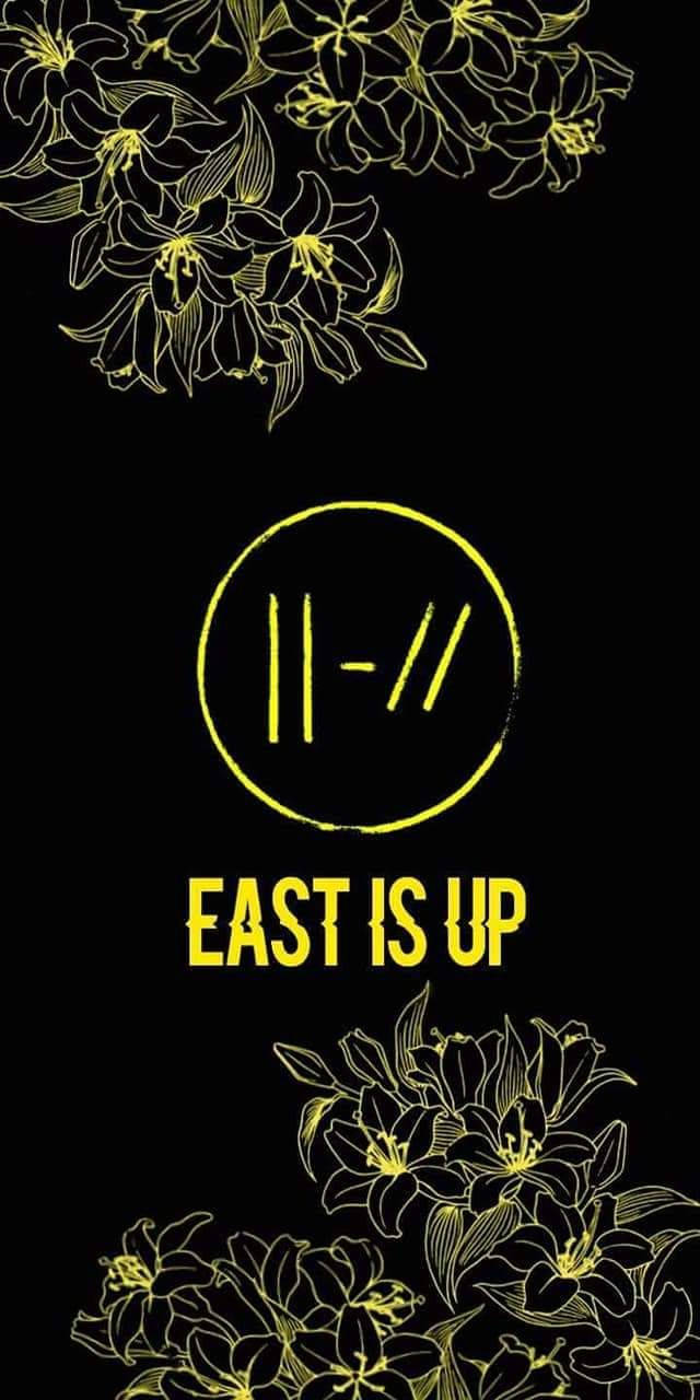 黑色背景上黃色花卉輪廓和文字，中間有「EAST IS UP」。