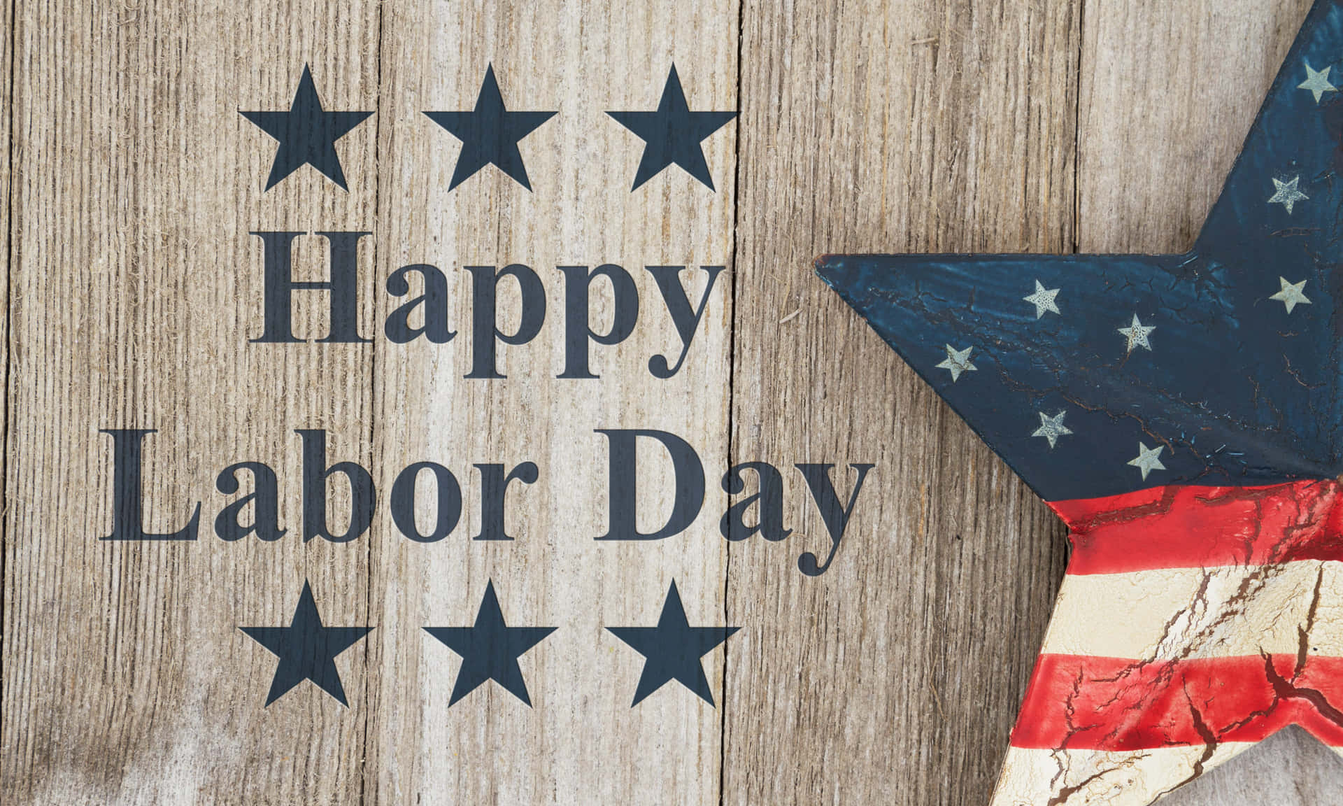 木背景上嘅「Happy Labor Day」文字，配有美國國旗星星裝飾。